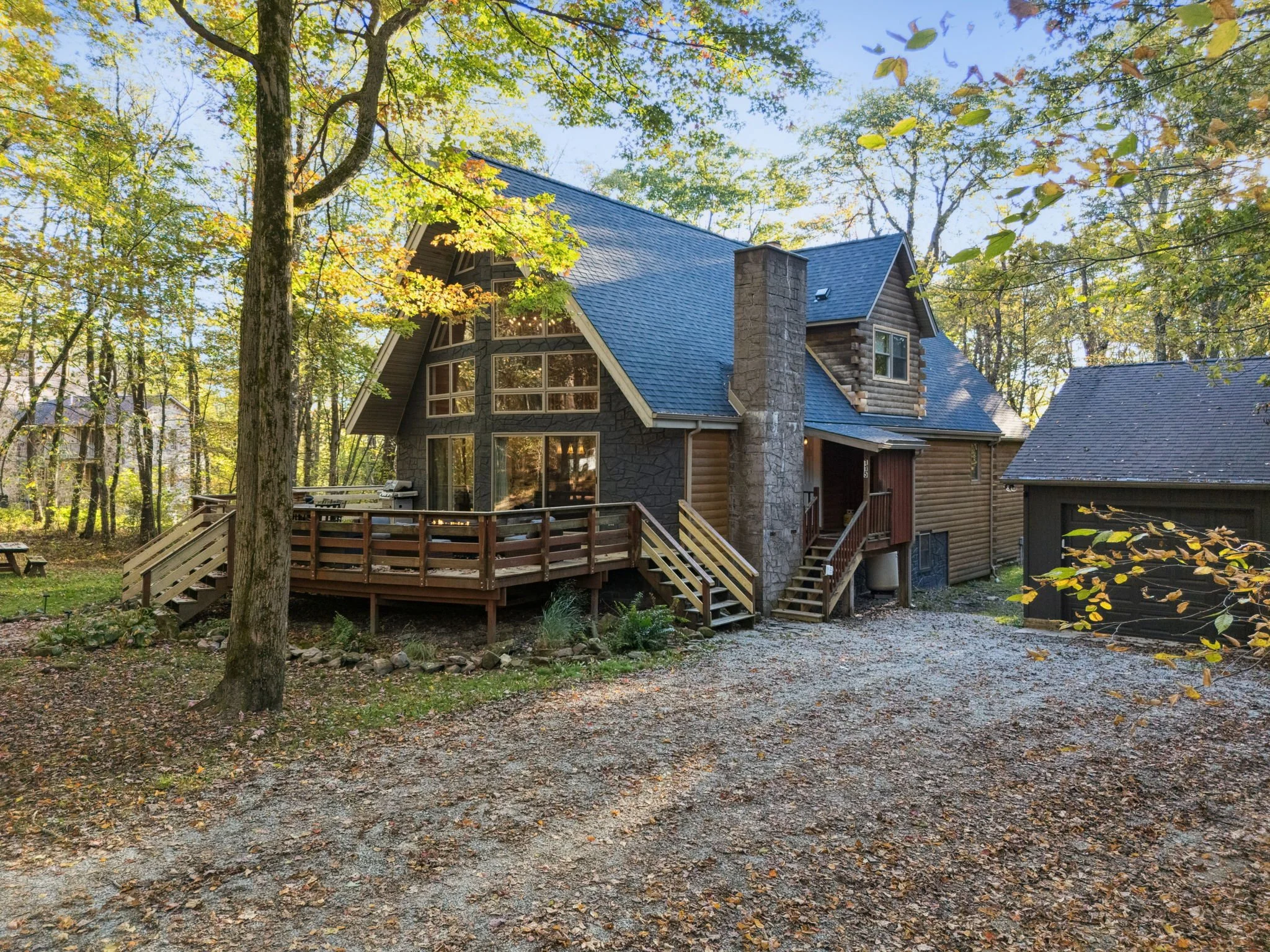 front exterior of black fern cabin, large entertaining deck in private forest area