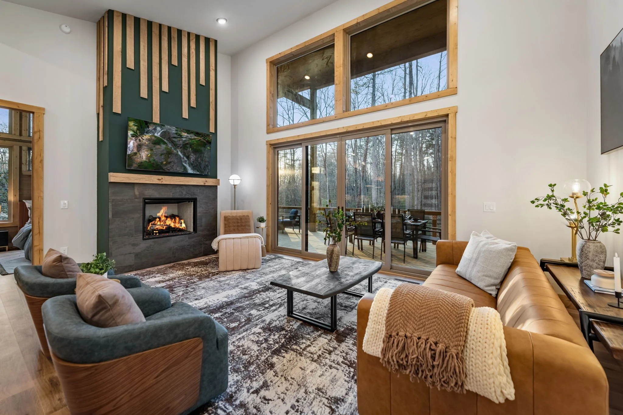 Spacious modern living room in Blue Fern with large window overlooking forest views
