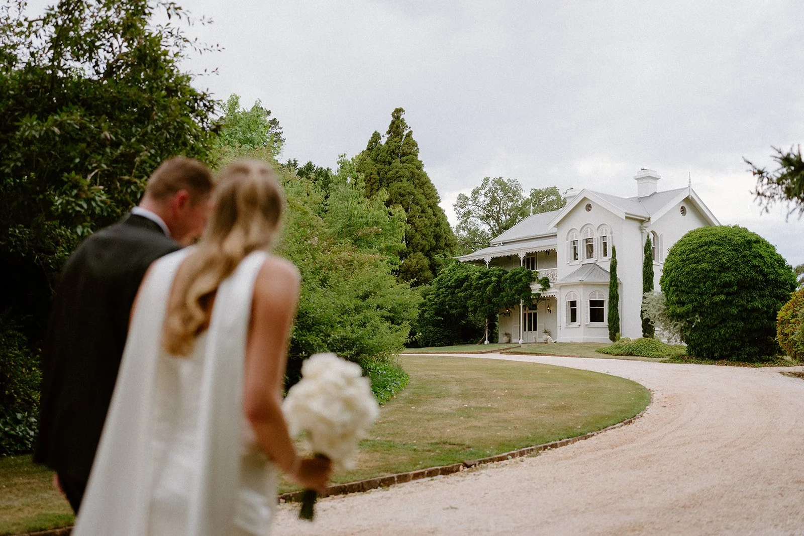 A stunning view of the Somerley House Homestead in the southern highlands with a newly married couple in the foreground