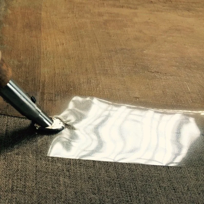 Application of an Acrylkleber 498 HV band around the entire painting and pressing it with a cauter through polyester foil.