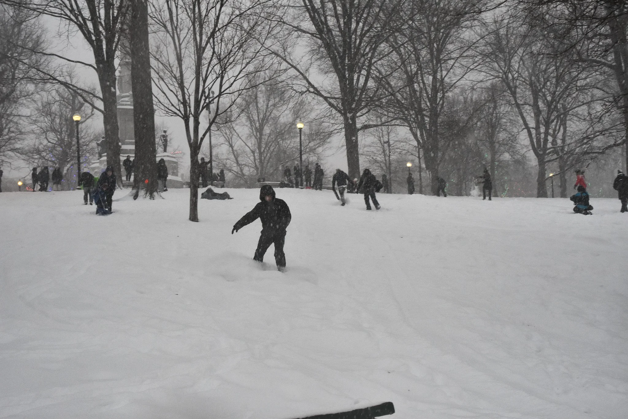 Boston, MA: Jan. 25 -  A snowboarder goes down the hill in the Boston Common. 
