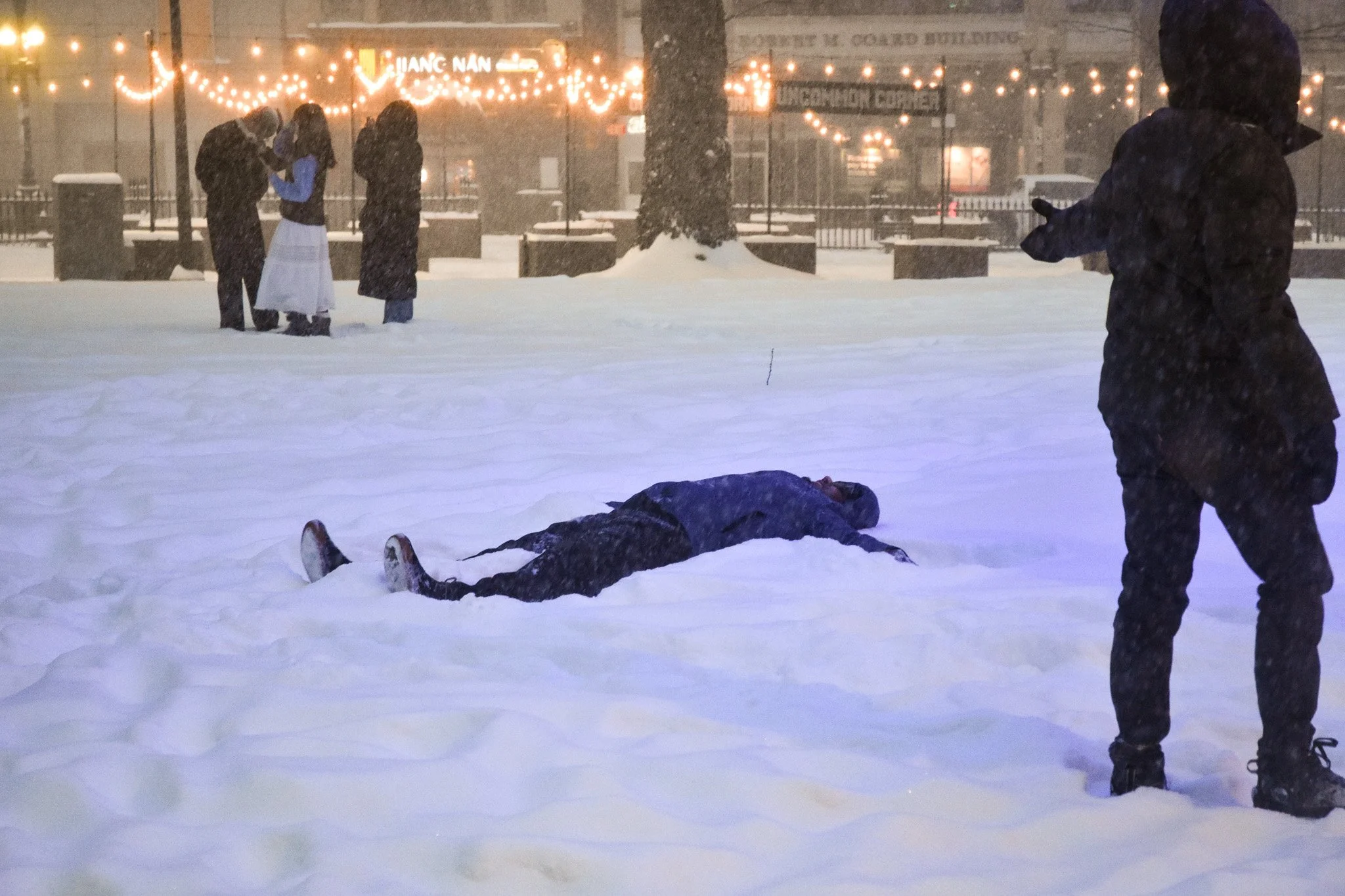 Boston, MA: Jan. 25 -  A person makes a snow angel by the Uncommon Stage. 