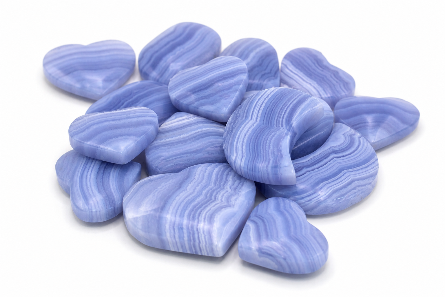 Collection of polished blue and white striped heart-shaped Blue Lace Agate crystals on a white background.