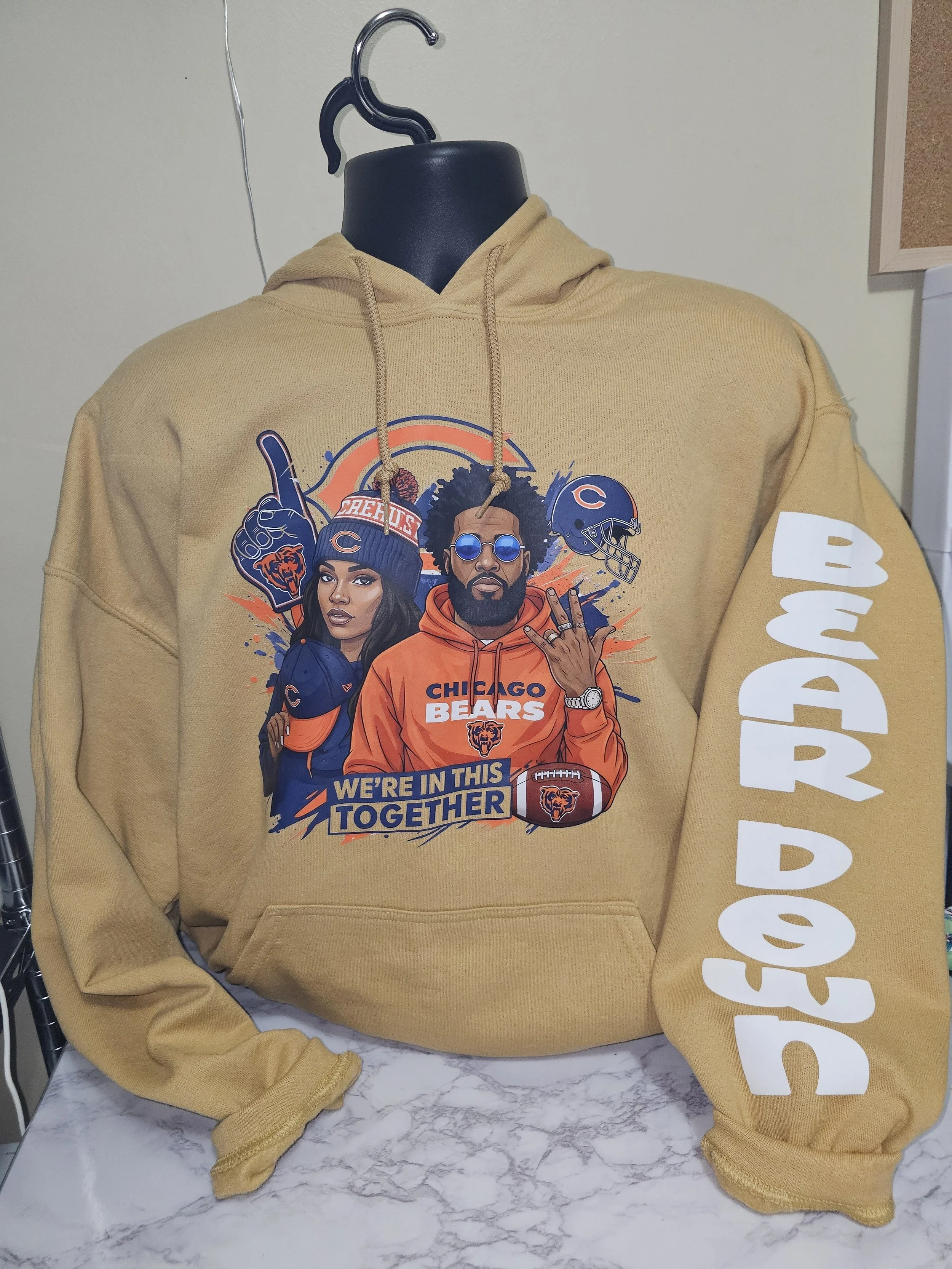 Decorative porch post with a black and brown leopard print pattern, a central black section with white text 'Home Sweet Home' inside a white leaf wreath, topped with a large silver bow and greenery, on a porch with potted plants and a tree in the background.