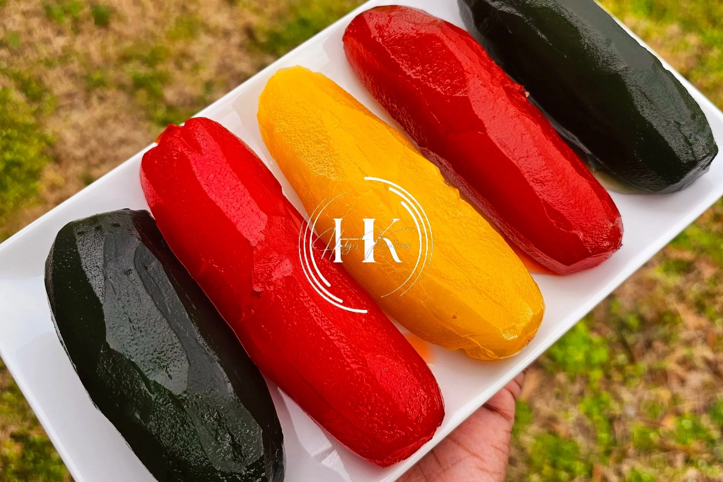 Decorative round wooden sign with the phrase "Welcome to our beautiful chaos" in black lettering, adorned with a white bow and greenery at the top, hanging on a black door surrounded by stone walls.