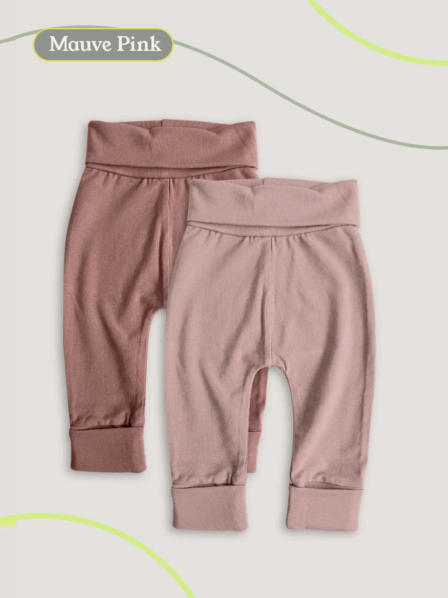 Flat lay of two pairs of baby pants in mauve and pink on a neutral background.