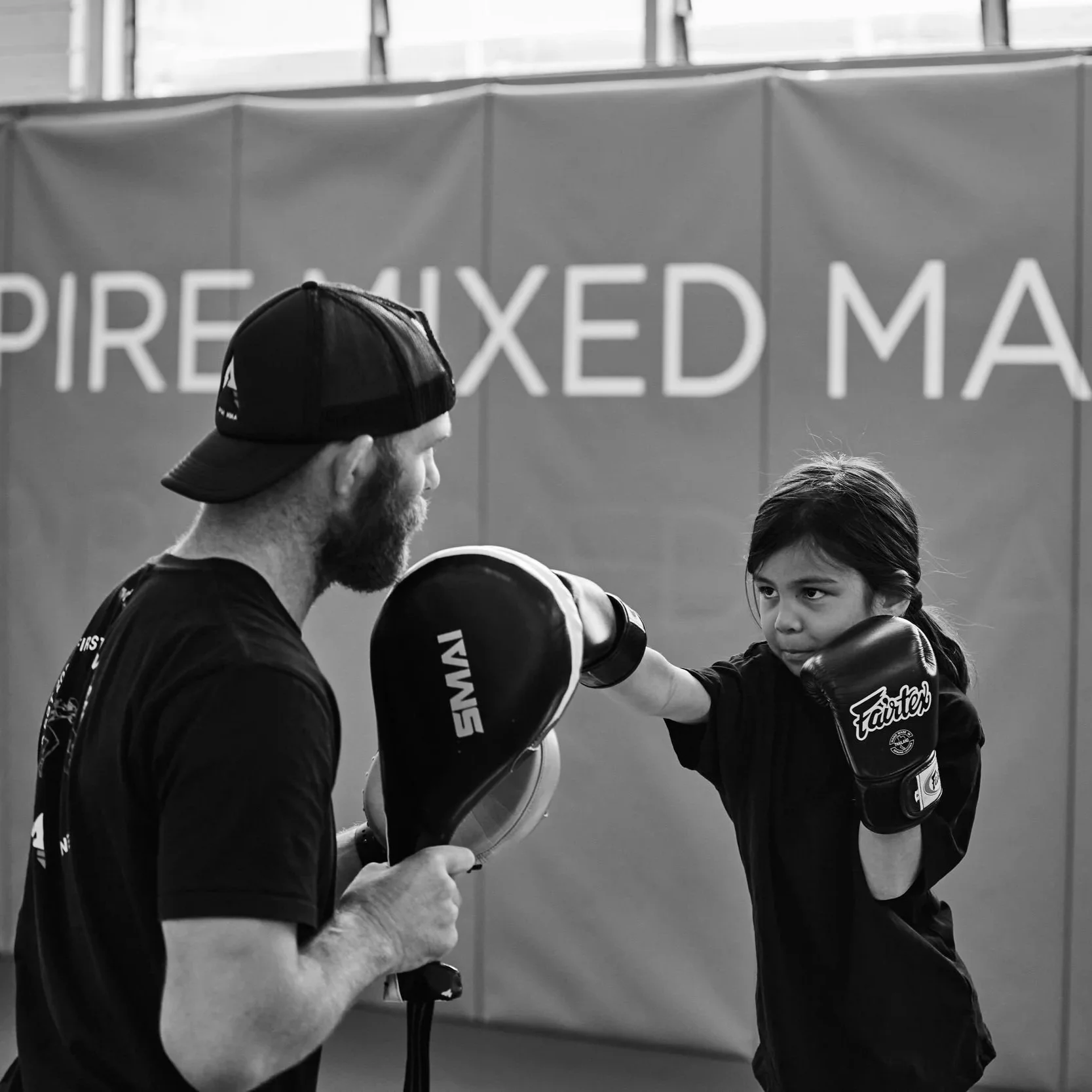 Aspire MMA gym, coach and student doing a lesson. Kids self-defence, boxing, MMA, UFC, boxing, BJJ, grappling, jiu jitsu, wrestling, self-defence, kick boxing, fitness, community. little legends class
