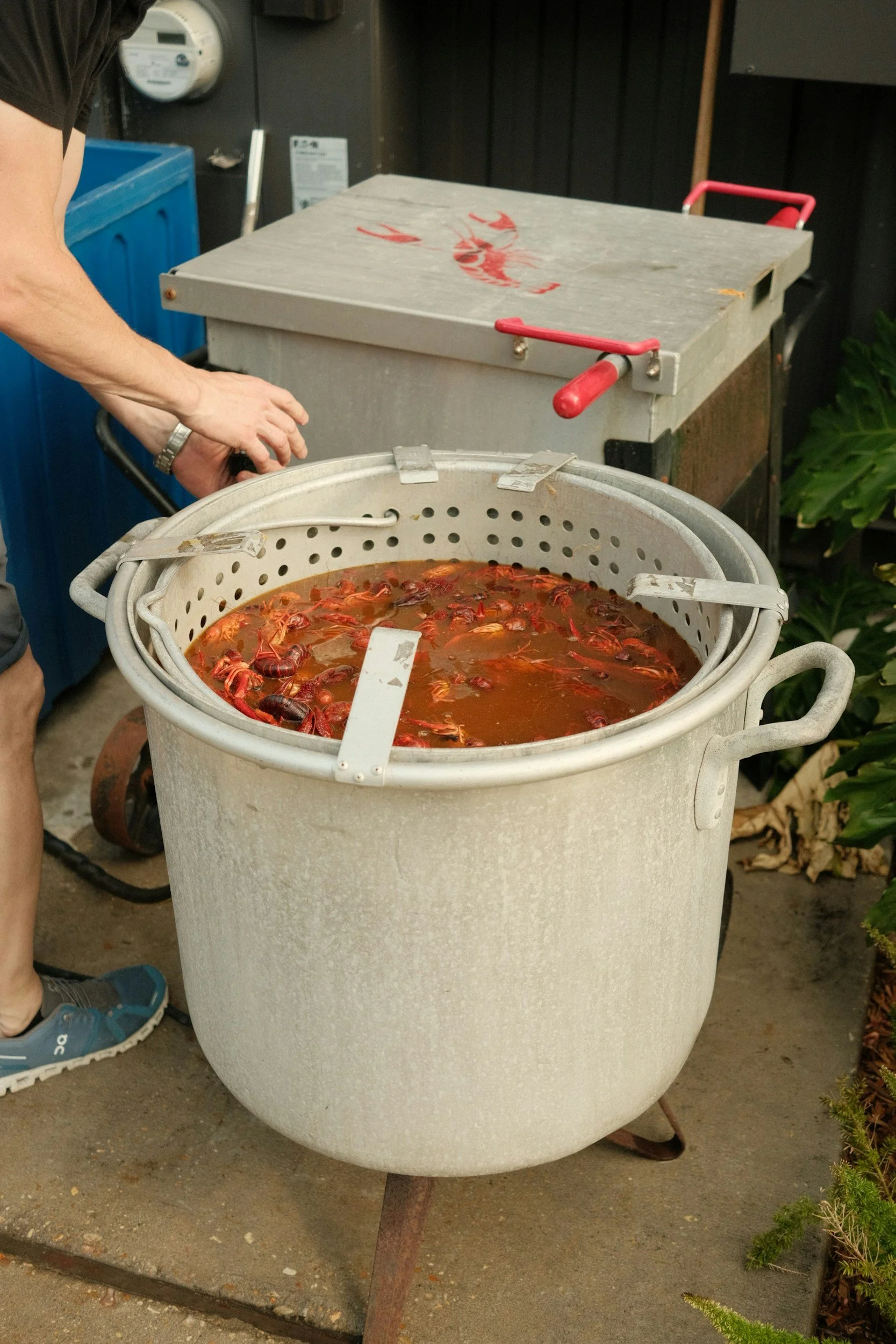 man tending to two crawfish pots