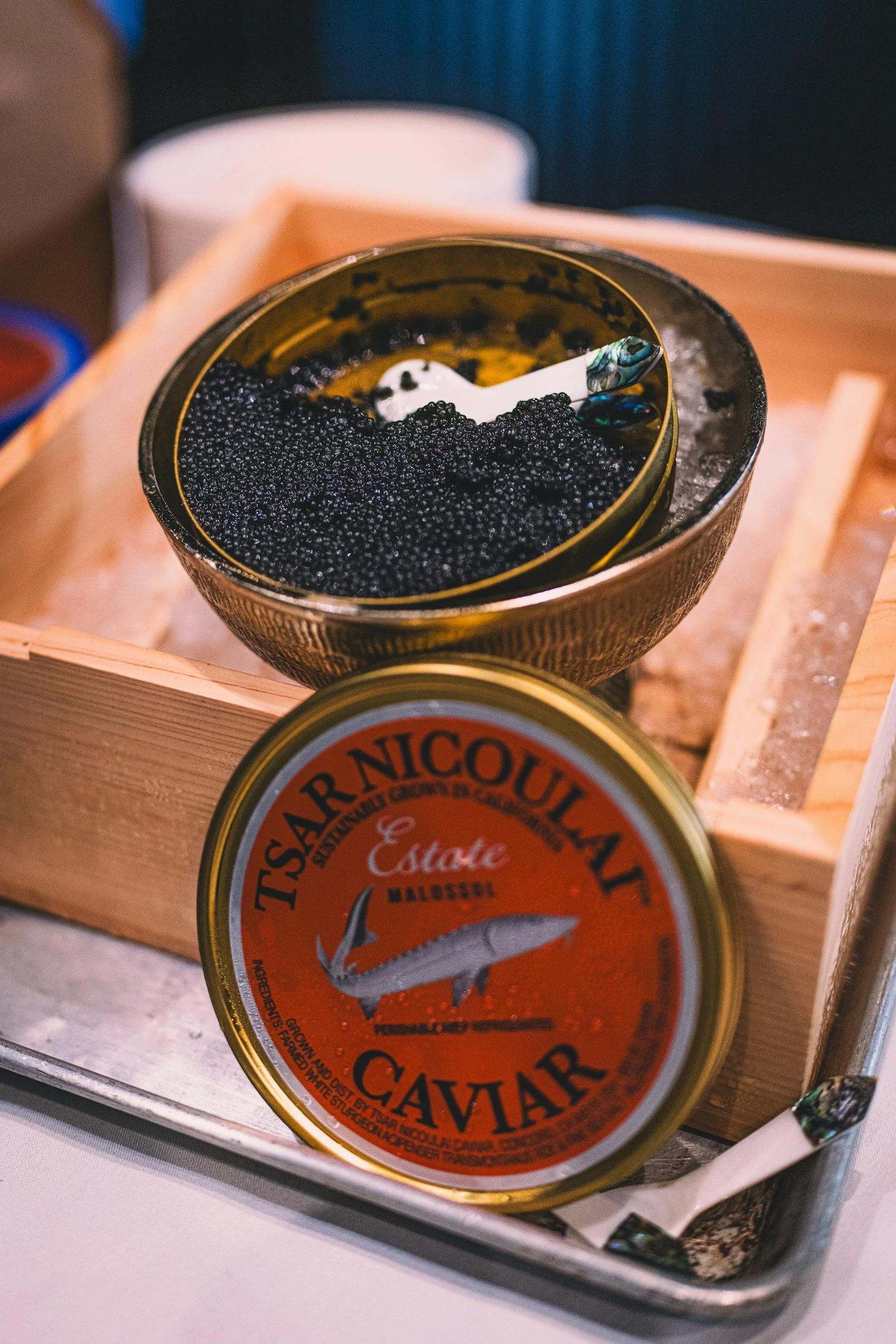 A mother of pearl caviar spoon sitting in caviar