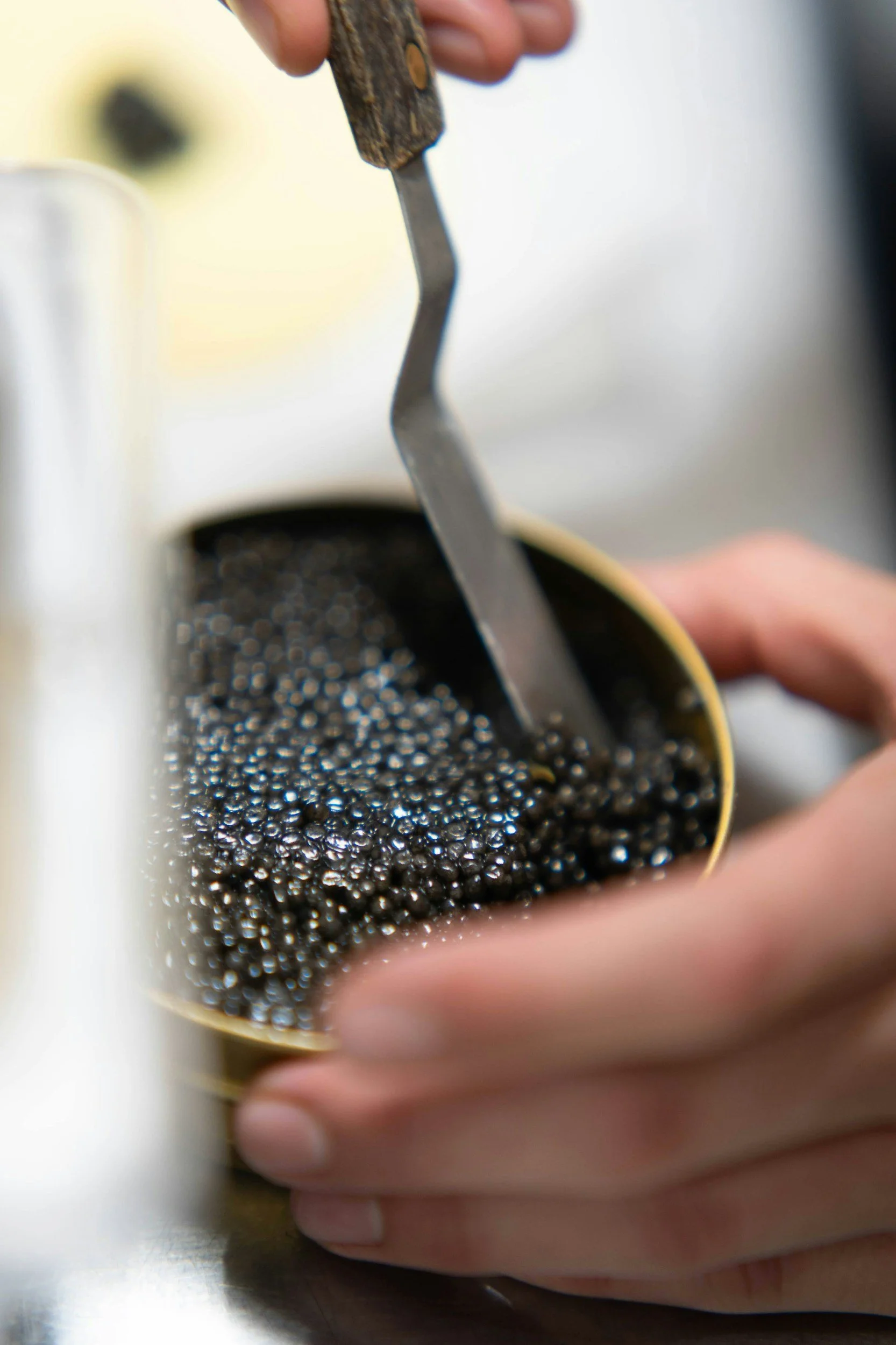 A hand scooping caviar
