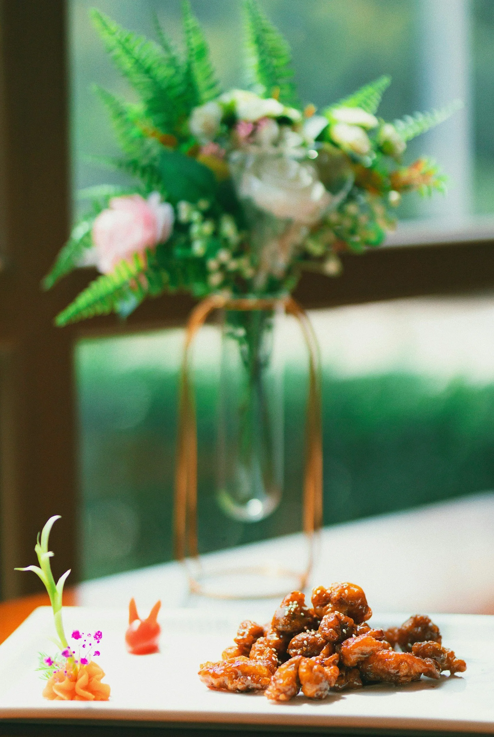 A refined shrimp dish in front of a vase