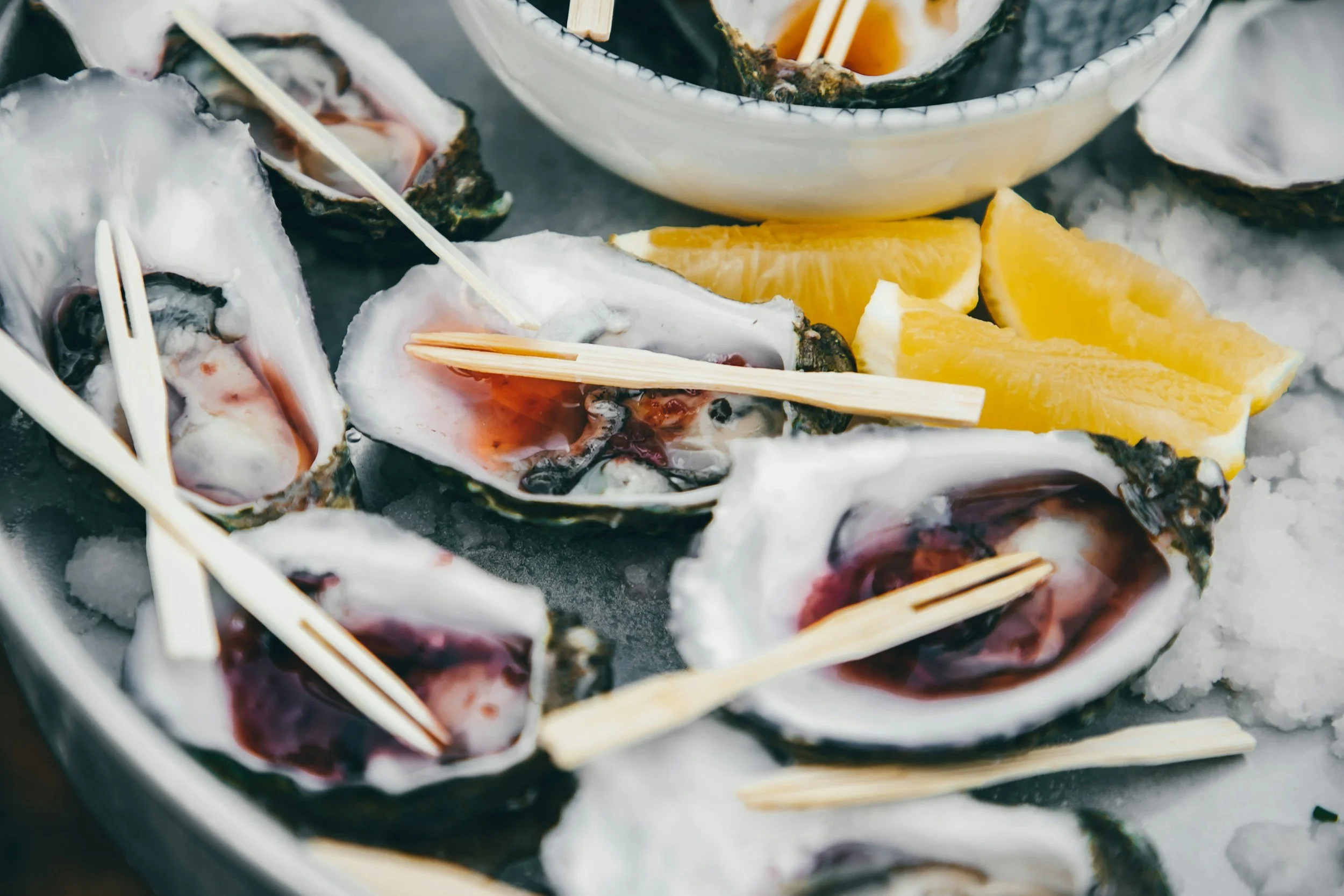 oysters on ice with red liquid