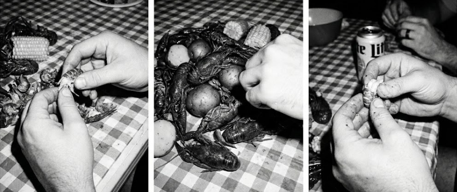 several people enjoying crawfish at a messy table
