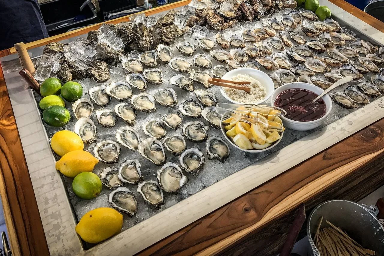 a raw bar full of oysters and sauces