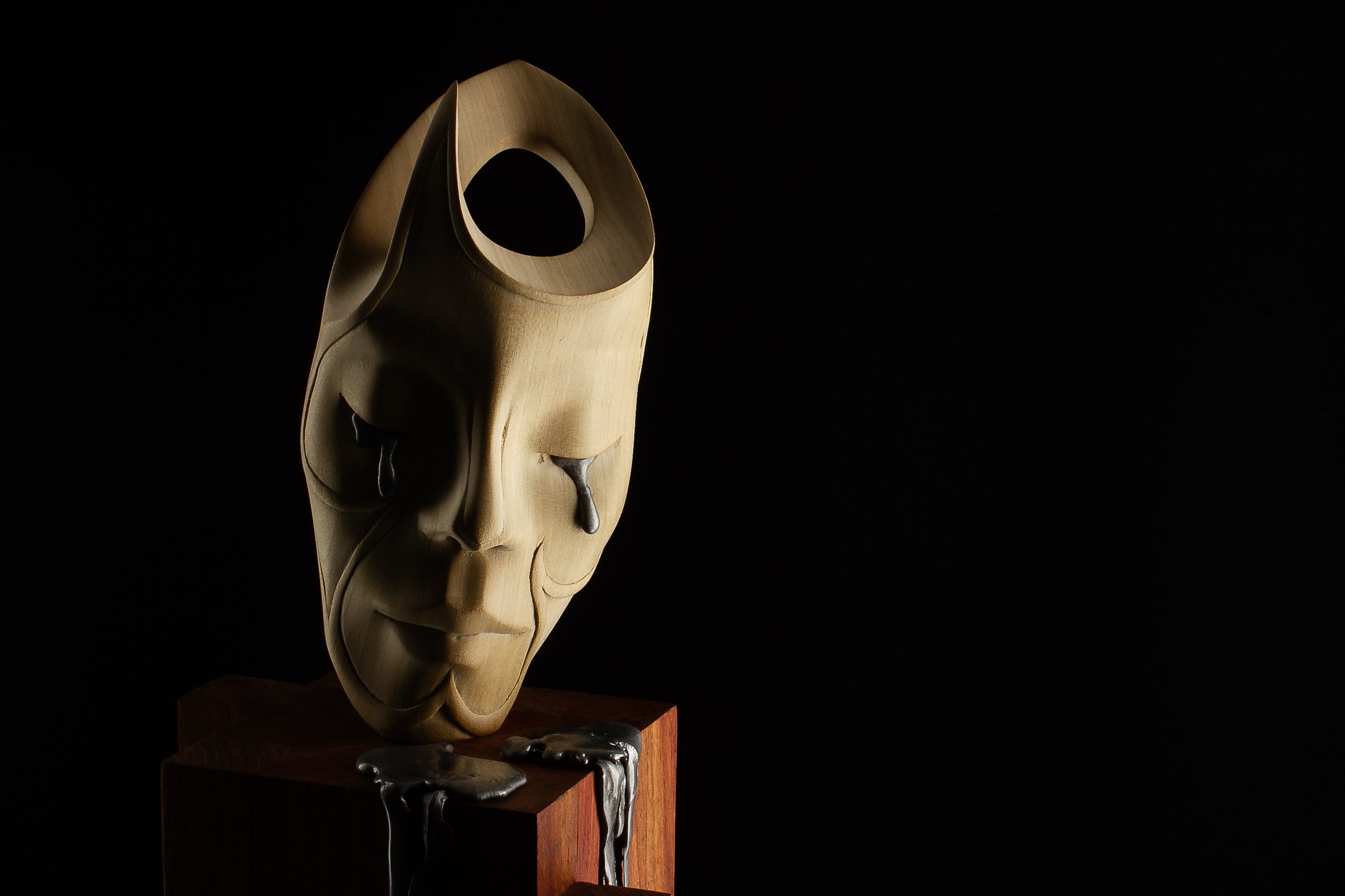 Paradox of Serenity – mixed-media sculpture by Arran Scott featuring molten lead tears.