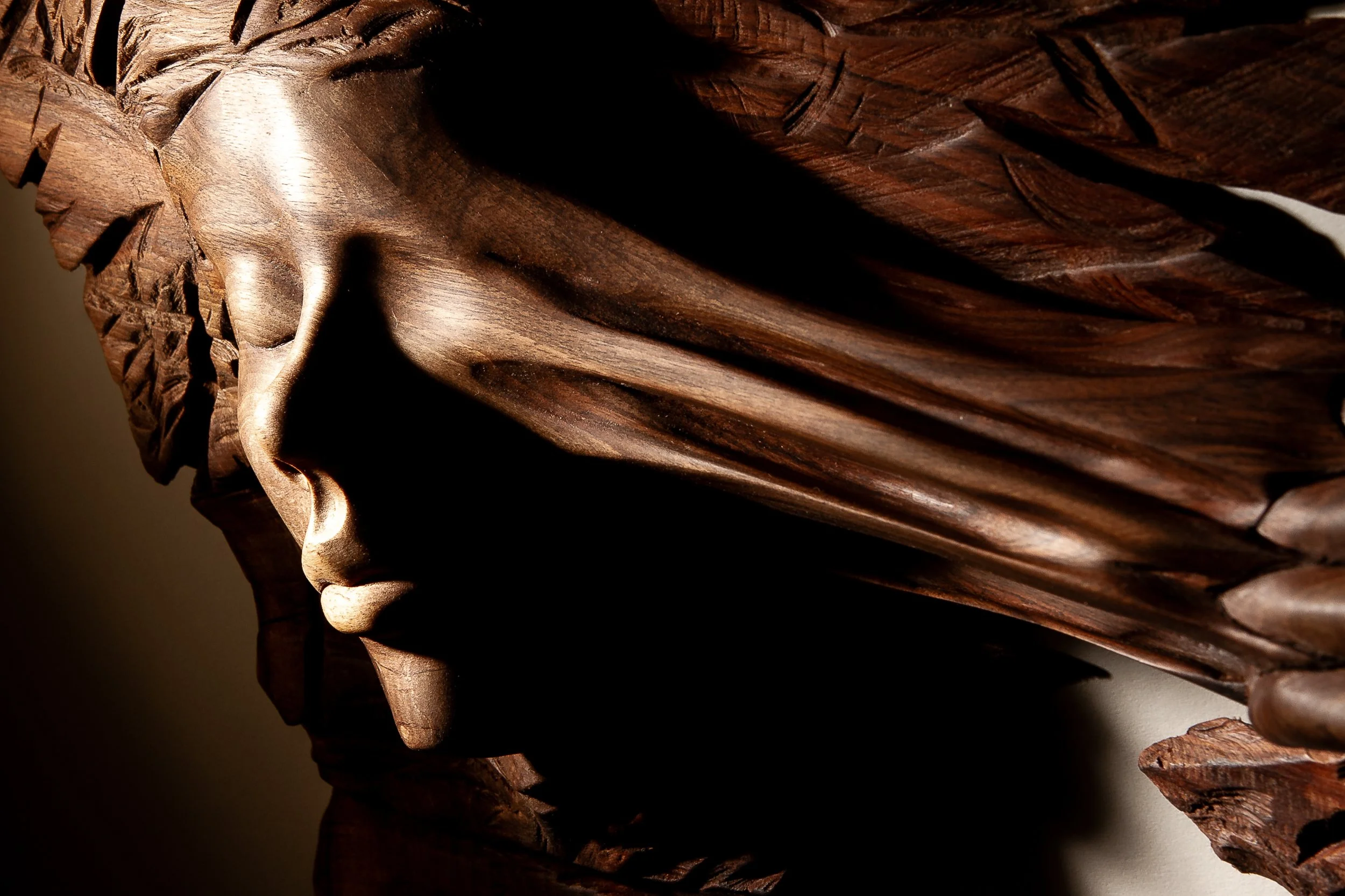 Where Chaos Found Her – hand-carved walnut sculpture by Arran Scott, emerging from raw textured walnut.
