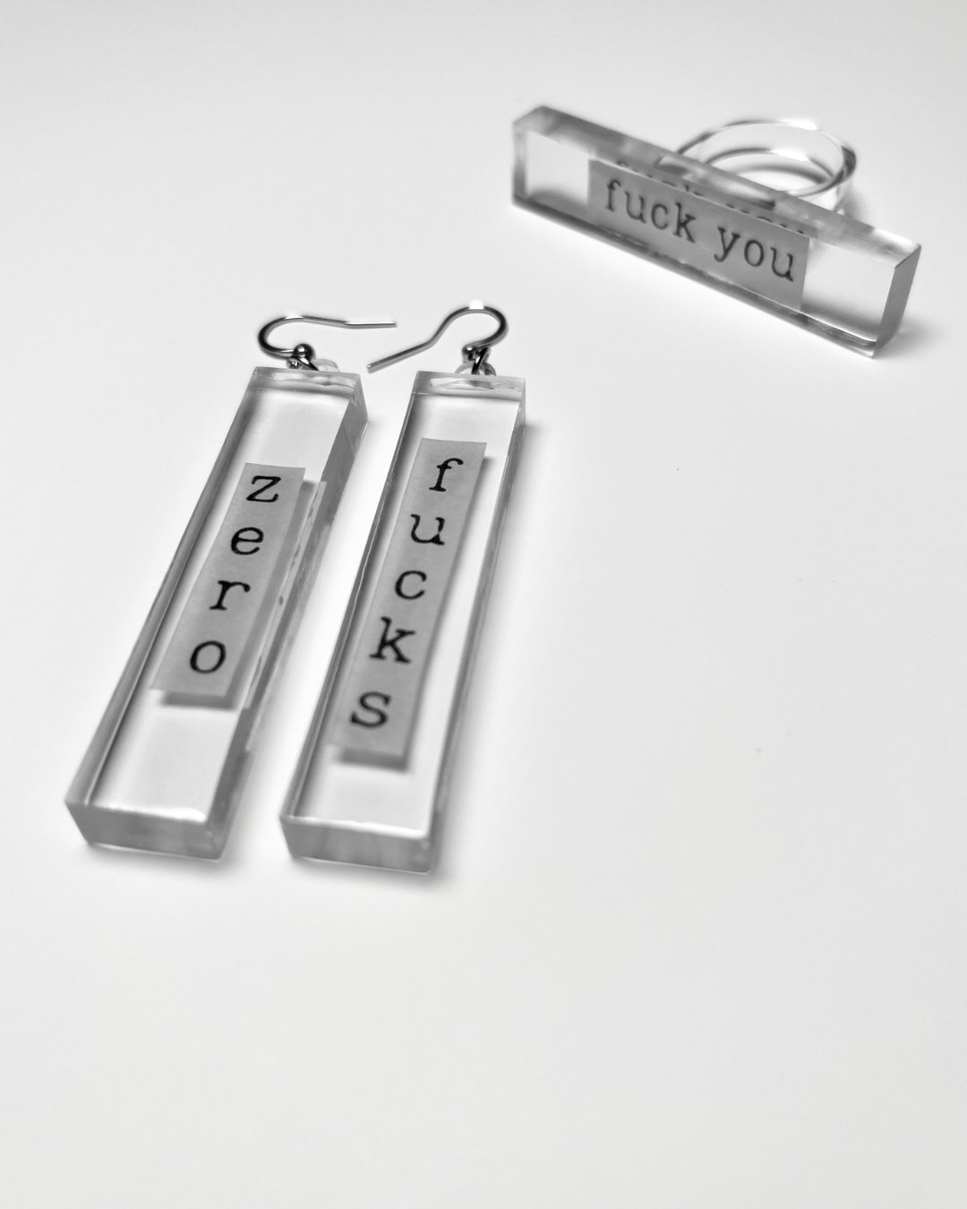ZERO FUCKS and FUCK YOU earrings and ring set.