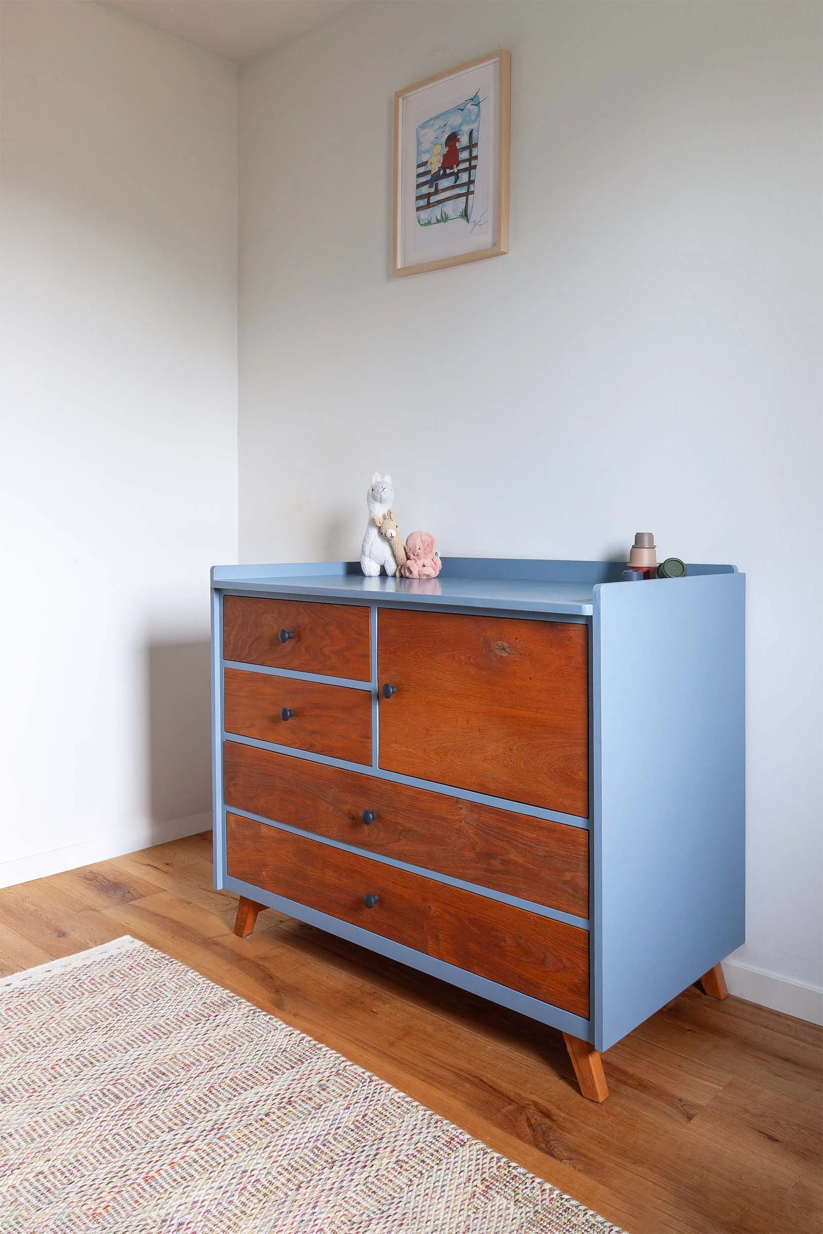 Blauwe commode met eikenhoutenfronten in een kamer met kleed