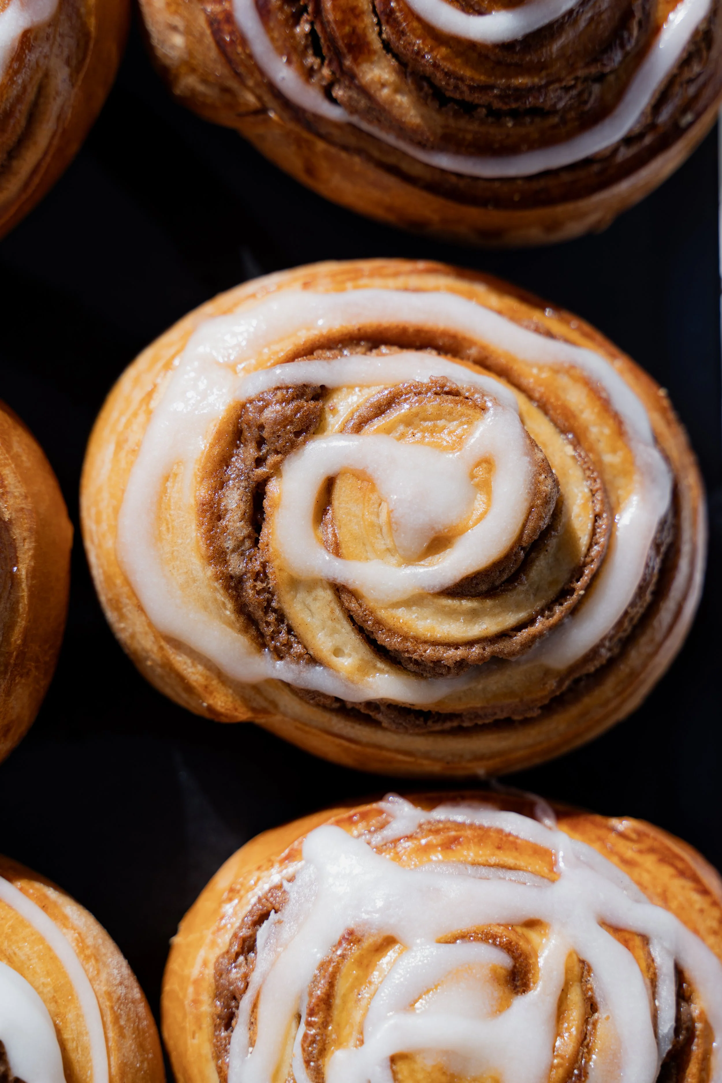 Cinnamon rolls con glaseado de azúcar, con interior de masa de canela y azúcar.