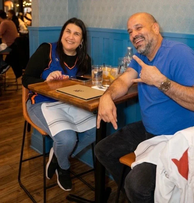 Two Knicks fans in jerseys at a table at Bourbon & Branch before the game.