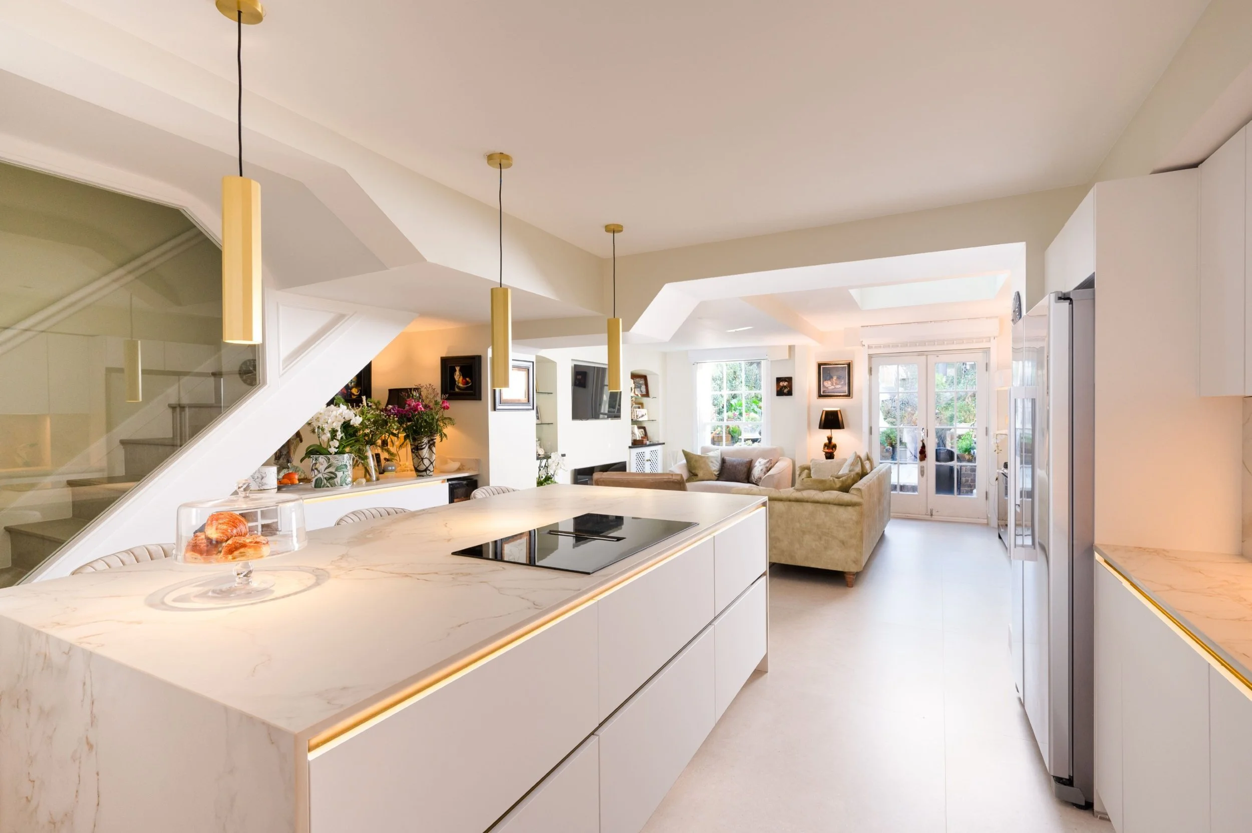 white quartz worktops in a white handleless kitchen