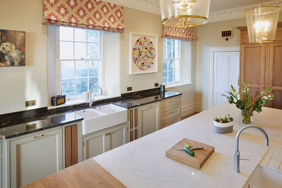 Classic kitchen worktop with marble worktops, farmhouse sink, and elegant decor.