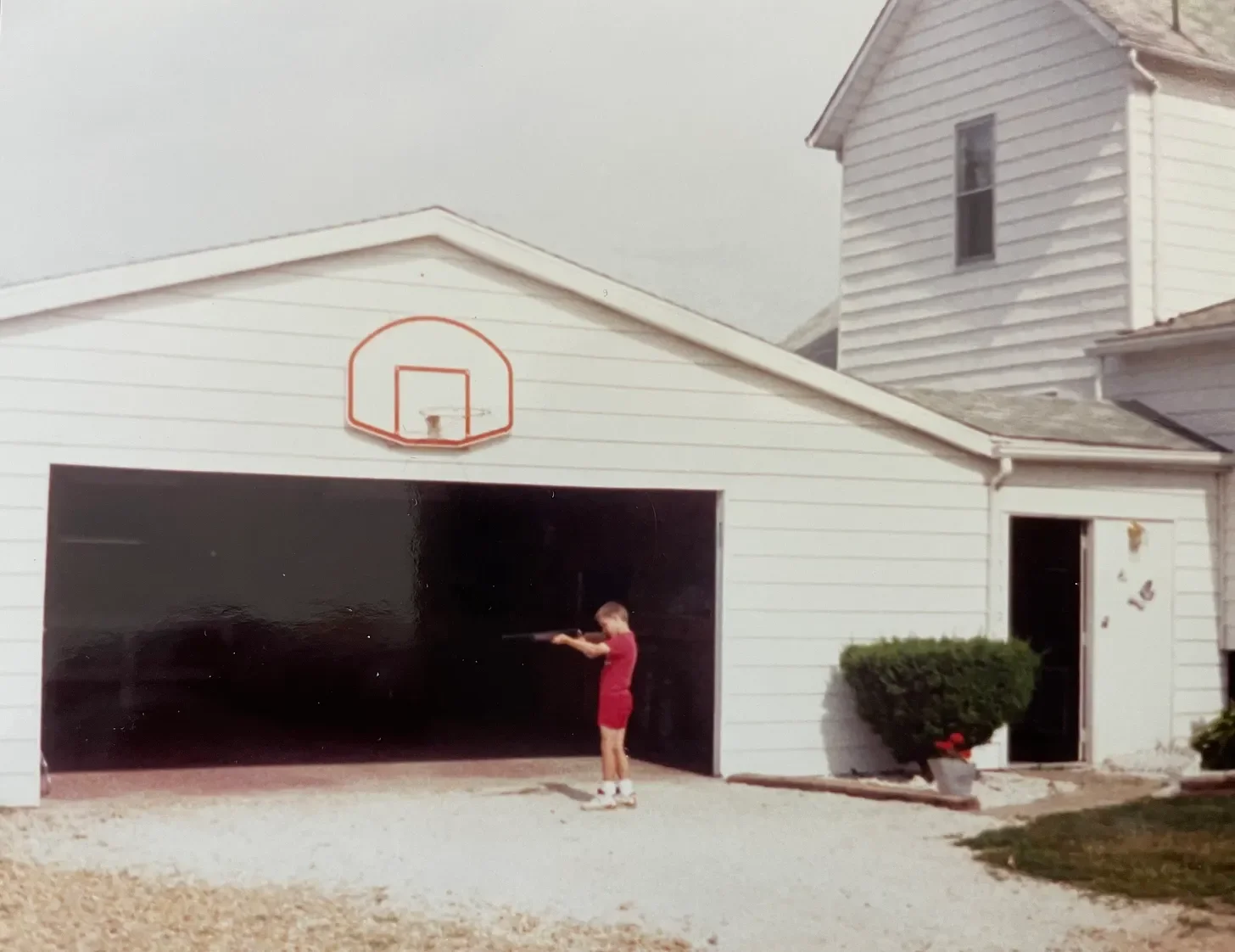 Substack told me to use a photo; here’s a random picture of me when I was probably 7, shooting a BB gun, in front of our haunted house.