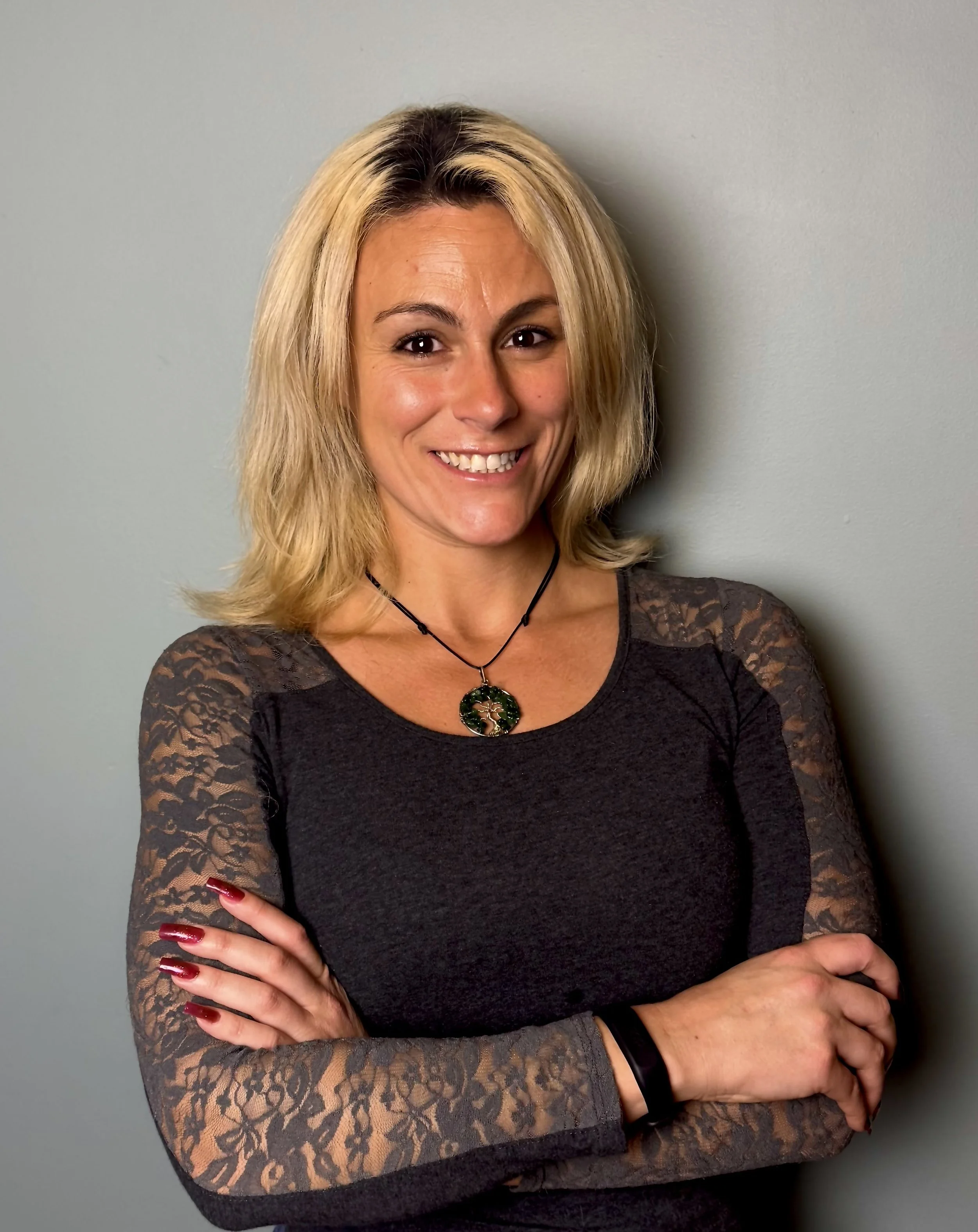 Smiling person wearing a white shirt against a white background.
