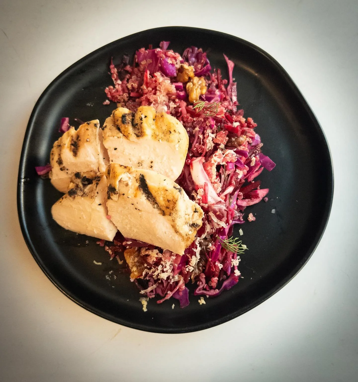 Brined, charcoal grilled chicken breast with &ldquo;purple salad.&rdquo; Shaved cabbage, radicchio, beets, Granny Smith, walnuts, quinoa, aged Gouda, brown mustard caraway vinaigrette. Elevated cooking, good ingredients, macro friendly.
