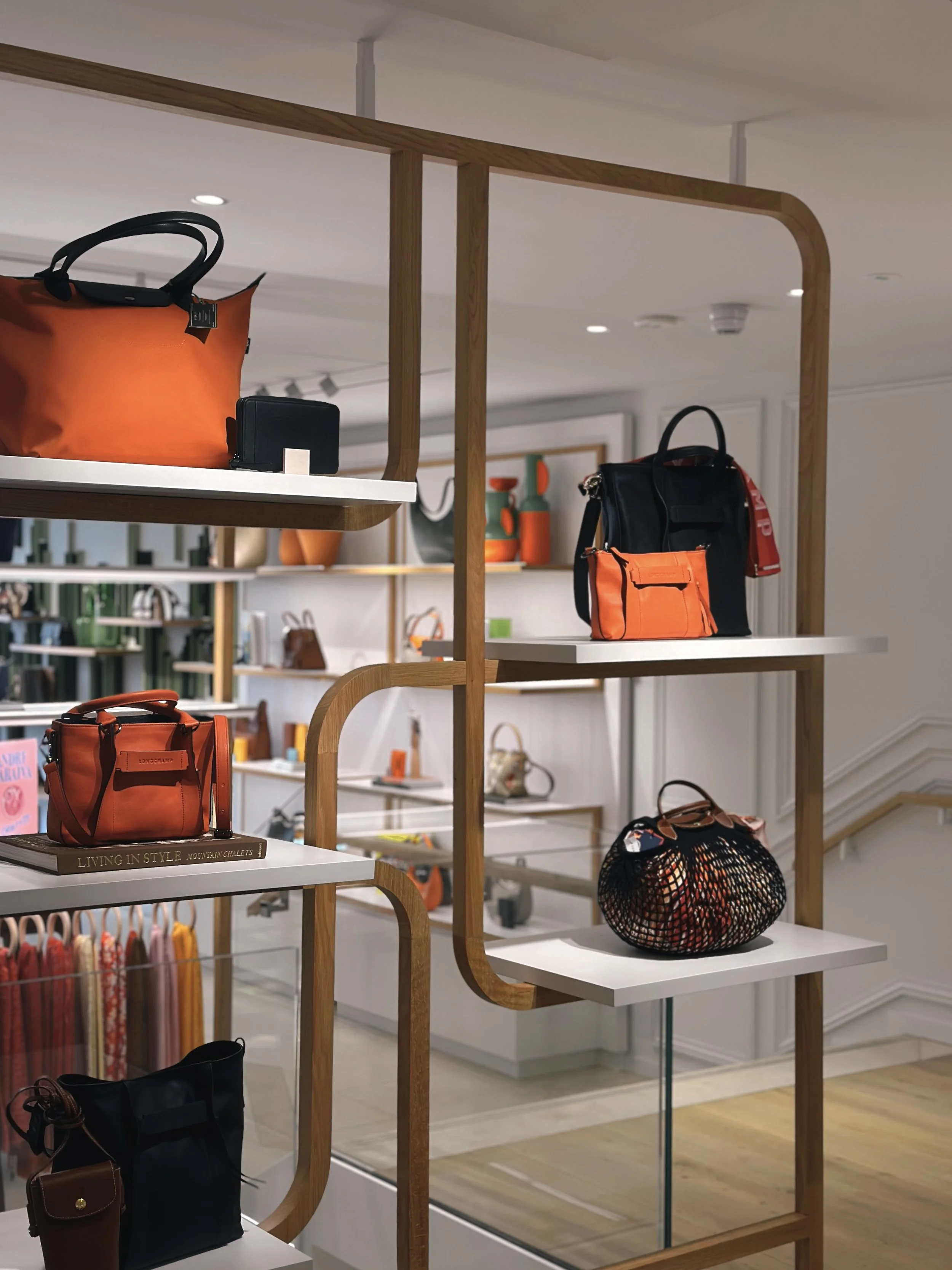 Display shelf with handbags and bags in a retail store.