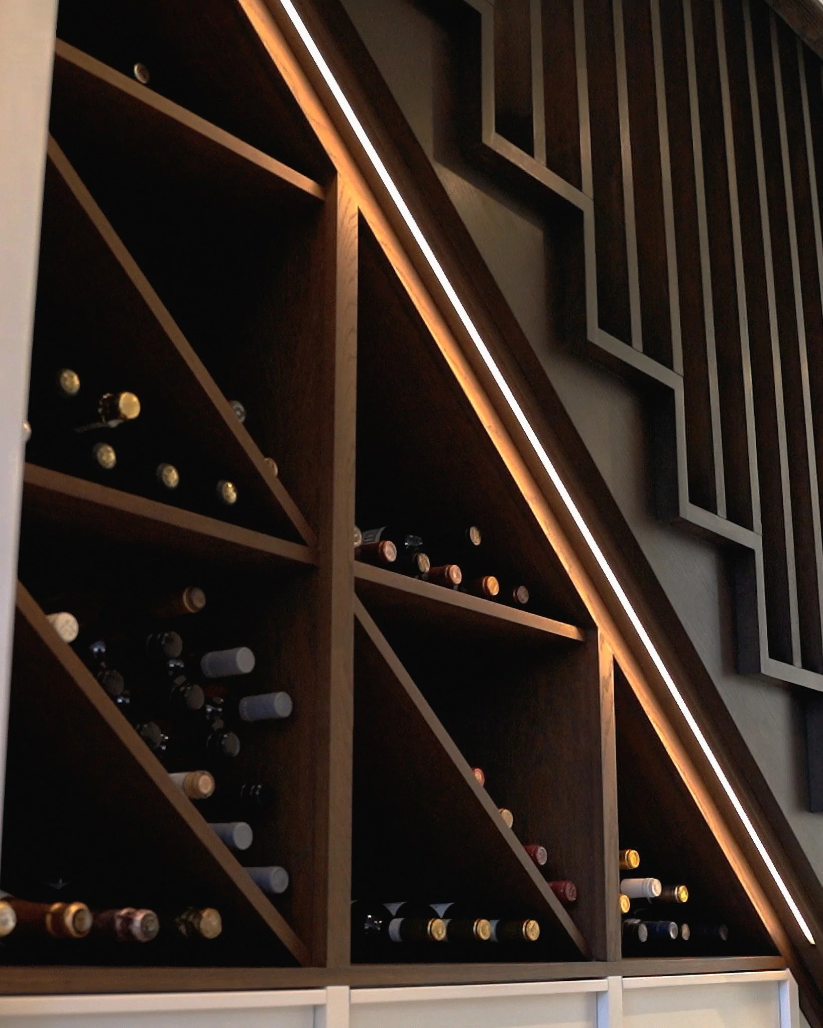 Good lighting can completely transform a space &mdash; and this custom staircase proves it.
With soft LED step lighting and a bespoke wine rack underneath, it turns a simple stairwell into a standout feature of the home.

 We love helping  bring crea
