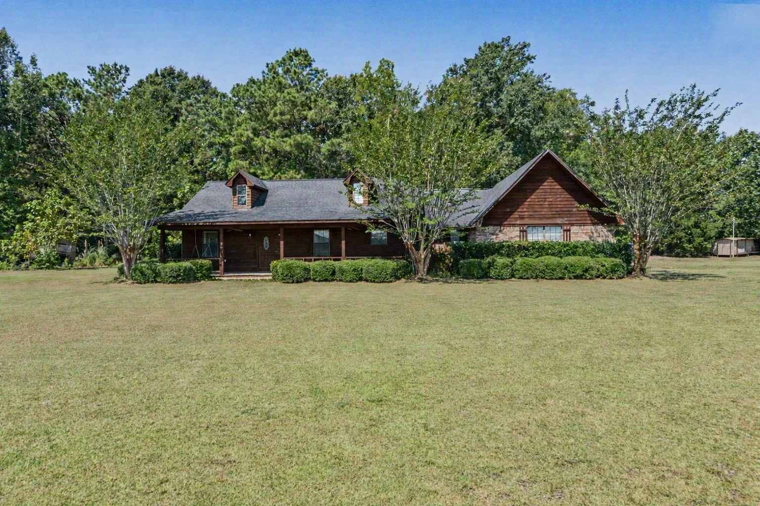 beautiful cedar and brick home with 2000 square feet and 3 bedrooms three bedrooms and 2 bathrooms two bathrooms and has five acres 5 acres with a workshop shed located on property and brick floors though out
