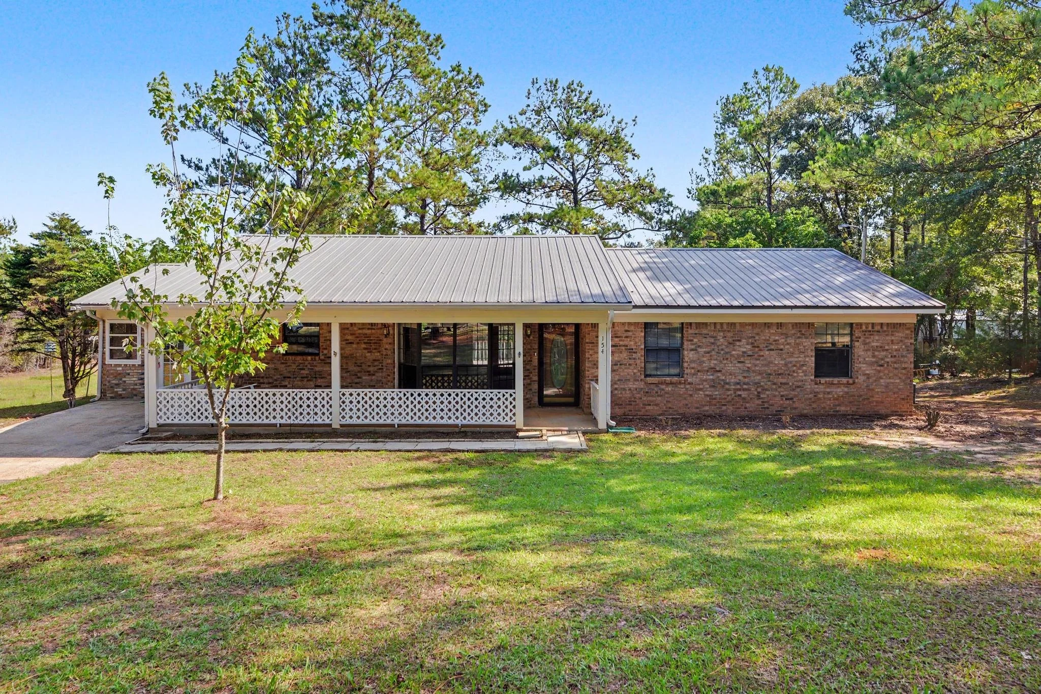 3 bedroom 2 bathroom home in lucedale mississippi in george county ms older home with white lattice on the front porch and has 2 acres beautiful home with wooden trim and accents