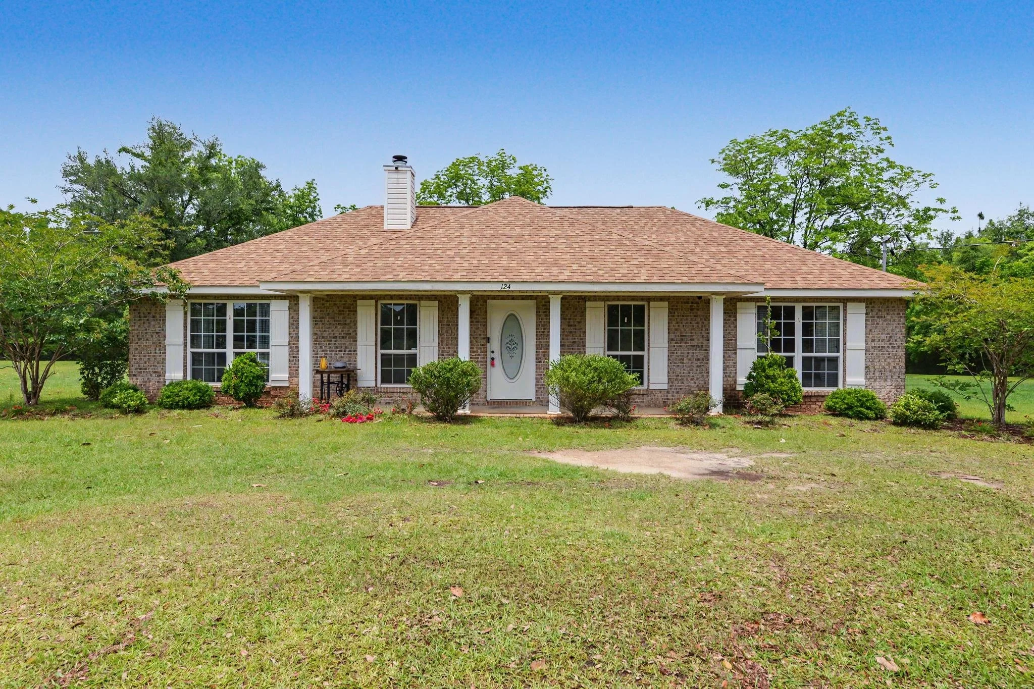 home located in lucedale, ms with 4 acres and three bedrooms and two baths with an enclosed pool cover over the in-ground pool with a workshop