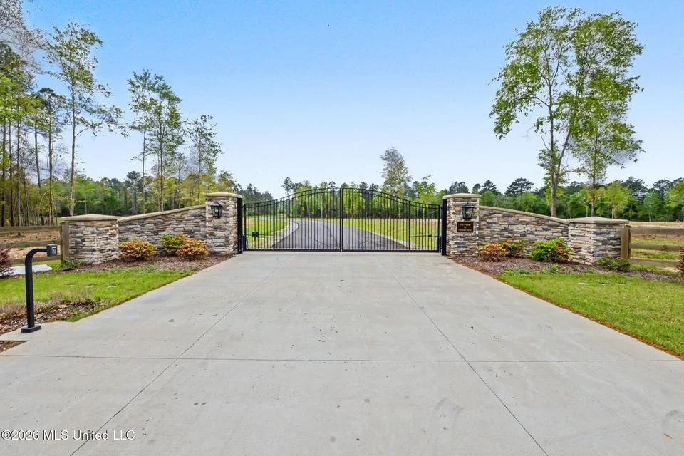 farms at cedar creek gate front entrance with lots of five plus acres located in george county ms