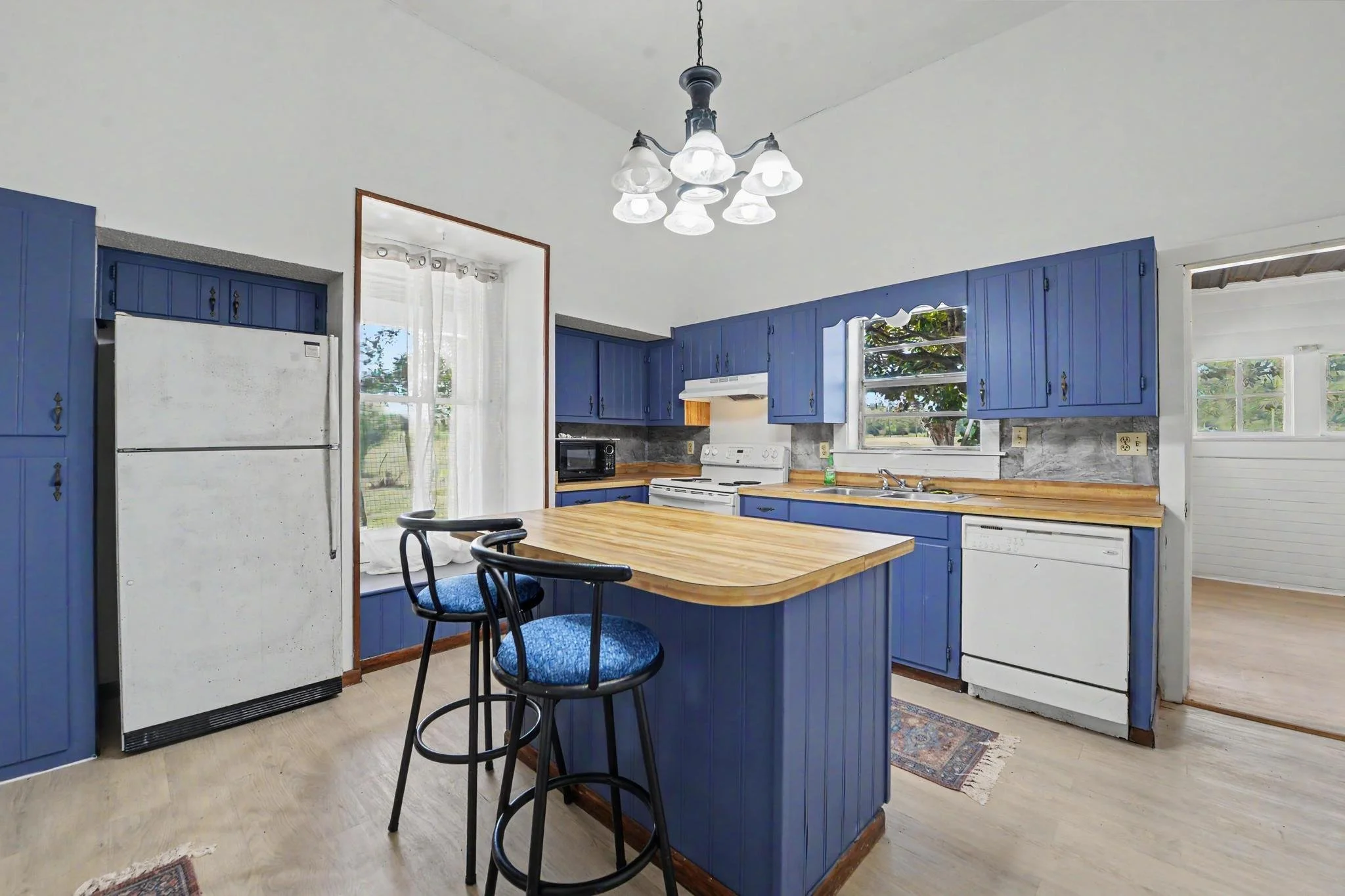 old white farmhouse with four acres and 3 bedrooms and 1 bathroom and a blue kitchen located in lucedale mississippi located in george county mississippi with 3 bedrooms and 1 bath