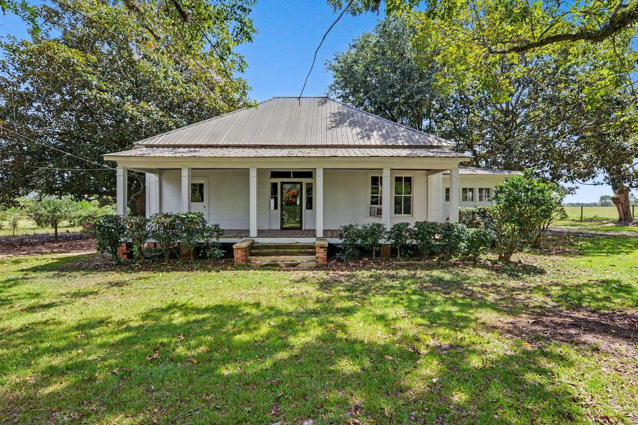 old white farmhouse with four acres and 3 bedrooms and 1 bathroom and a blue kitchen located in lucedale mississippi located in george county mississippi with 3 bedrooms and 1 bath