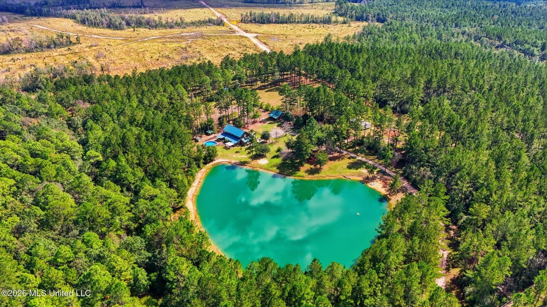 barndominium 26 acres in vancleave mississippi 7 bedrooms 6 bathrooms and 3719 square feet with 26.01 acres in jackson county mississippi with a separate living quarters upstairs and a 2 bedroo 1 bathroom cottage and stocked pond