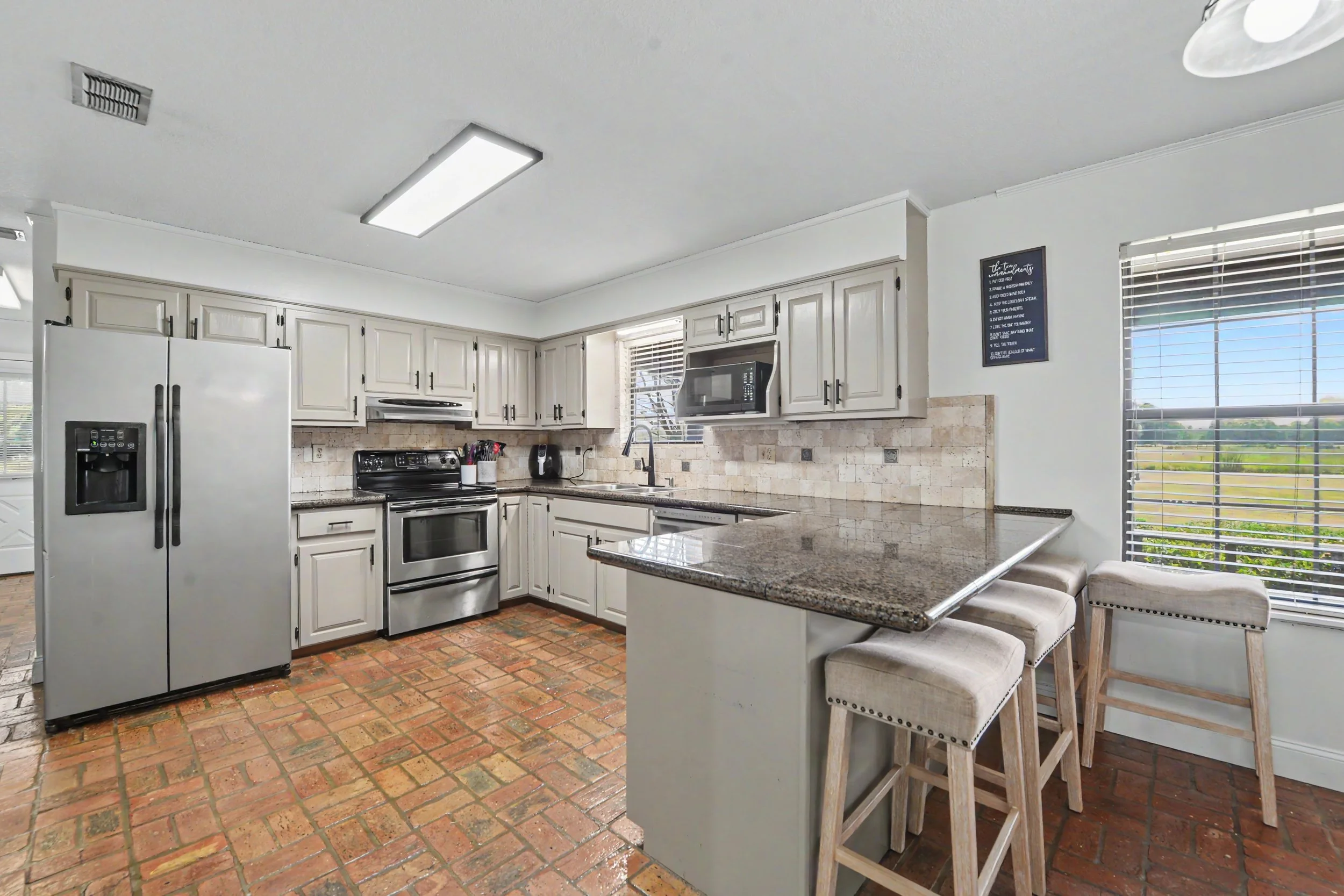 beautiful cedar and brick home with 2000 square feet and 3 bedrooms three bedrooms and 2 bathrooms two bathrooms and has five acres 5 acres with a workshop shed located on property and brick floors though out