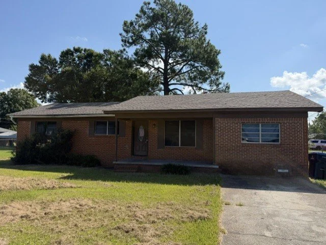 brick home inside lucedale city limits with 3 bedrooms three bedrooms and 2 bathrooms two bathrooms and a brick fireplace with a nice back porch