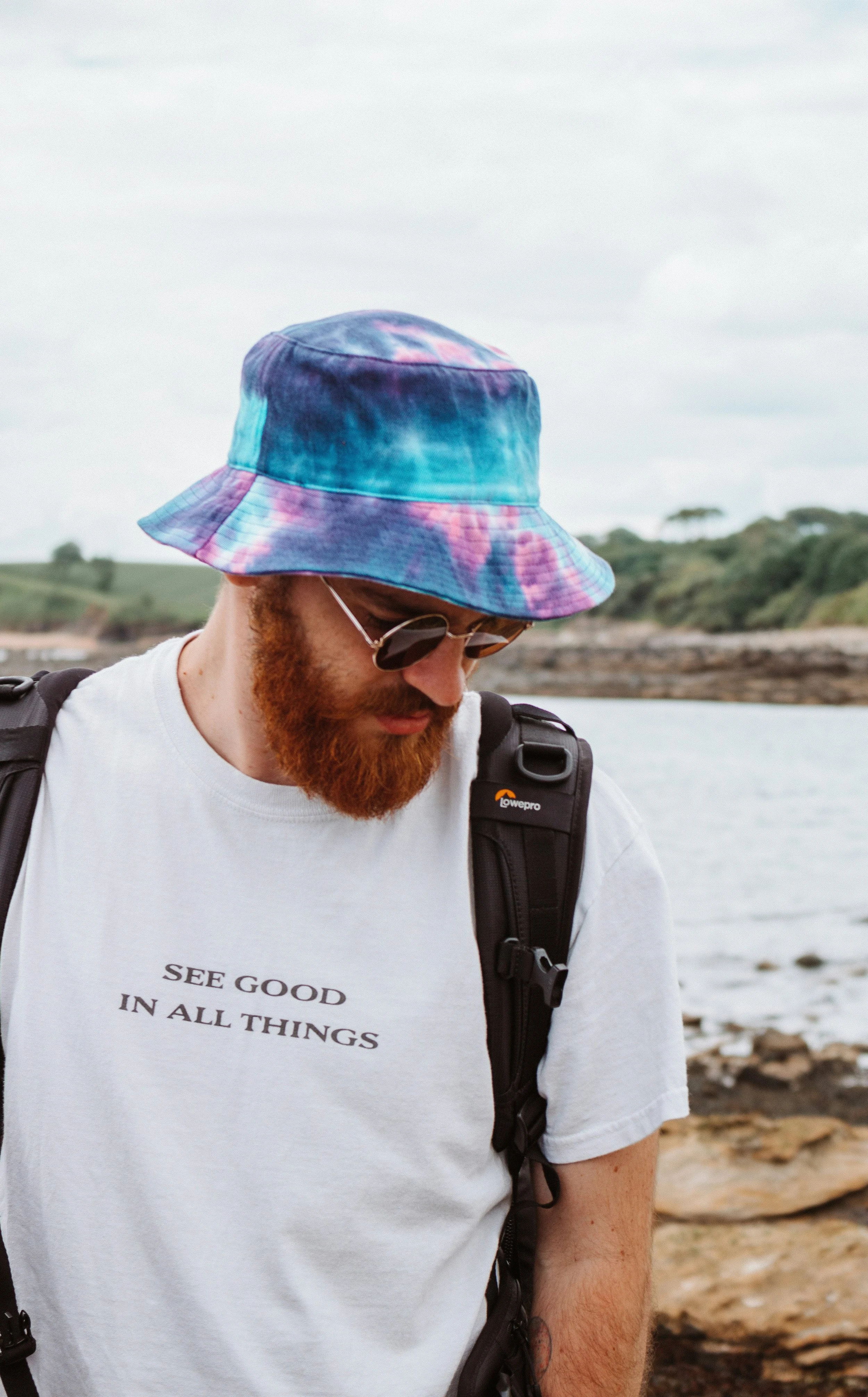 Man in casual outdoor clothing with head lowered, representing the underdiagnosed nature of male depression treated through therapy in Arlington, VA