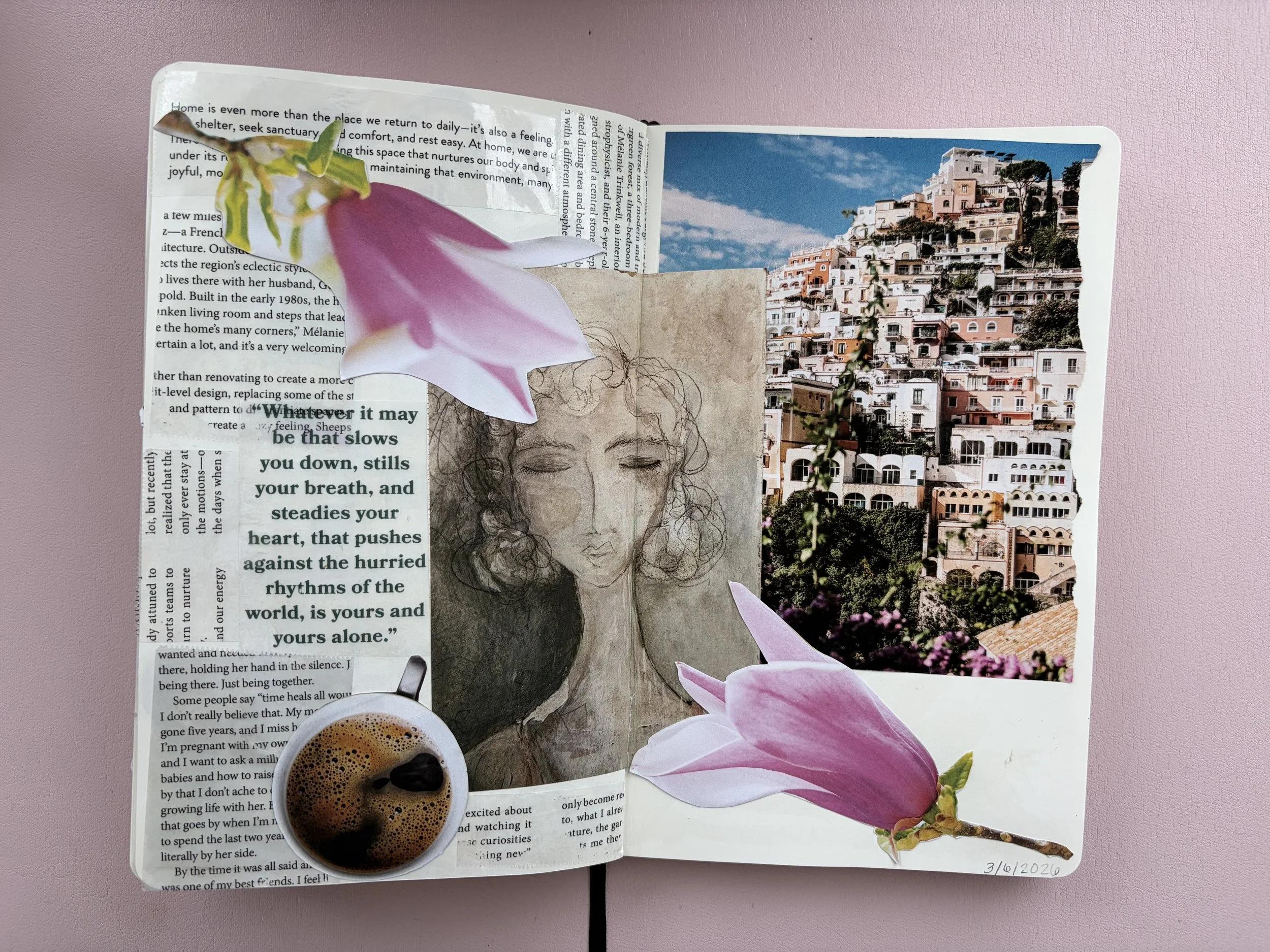 An open journal with a sketch of a woman, a quote about slowing down, a photo of a hillside town with colorful houses, two pink magnolia flowers, a small cup of coffee, and a handwritten date of 3/6/2026.
