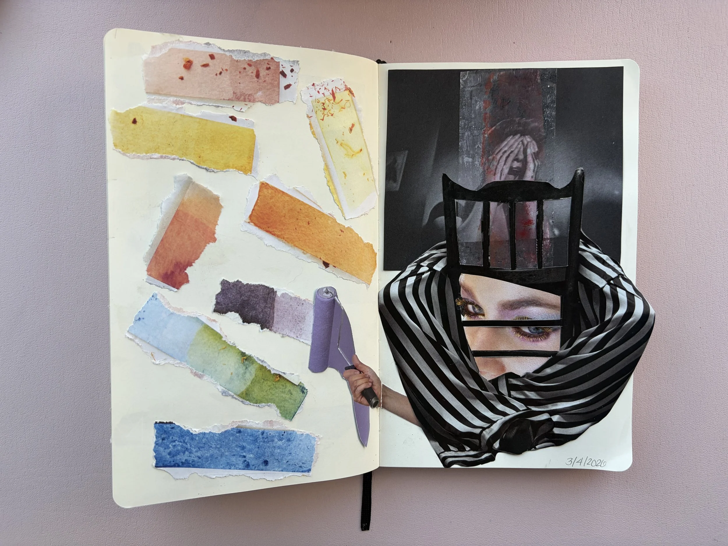 An open notebook with torn watercolor paint swatches on the left page, including pink, yellow, orange, purple, green, and blue. The right page features a collage of a woman's face with eyes and forehead visible, a black chair, and a dark background w