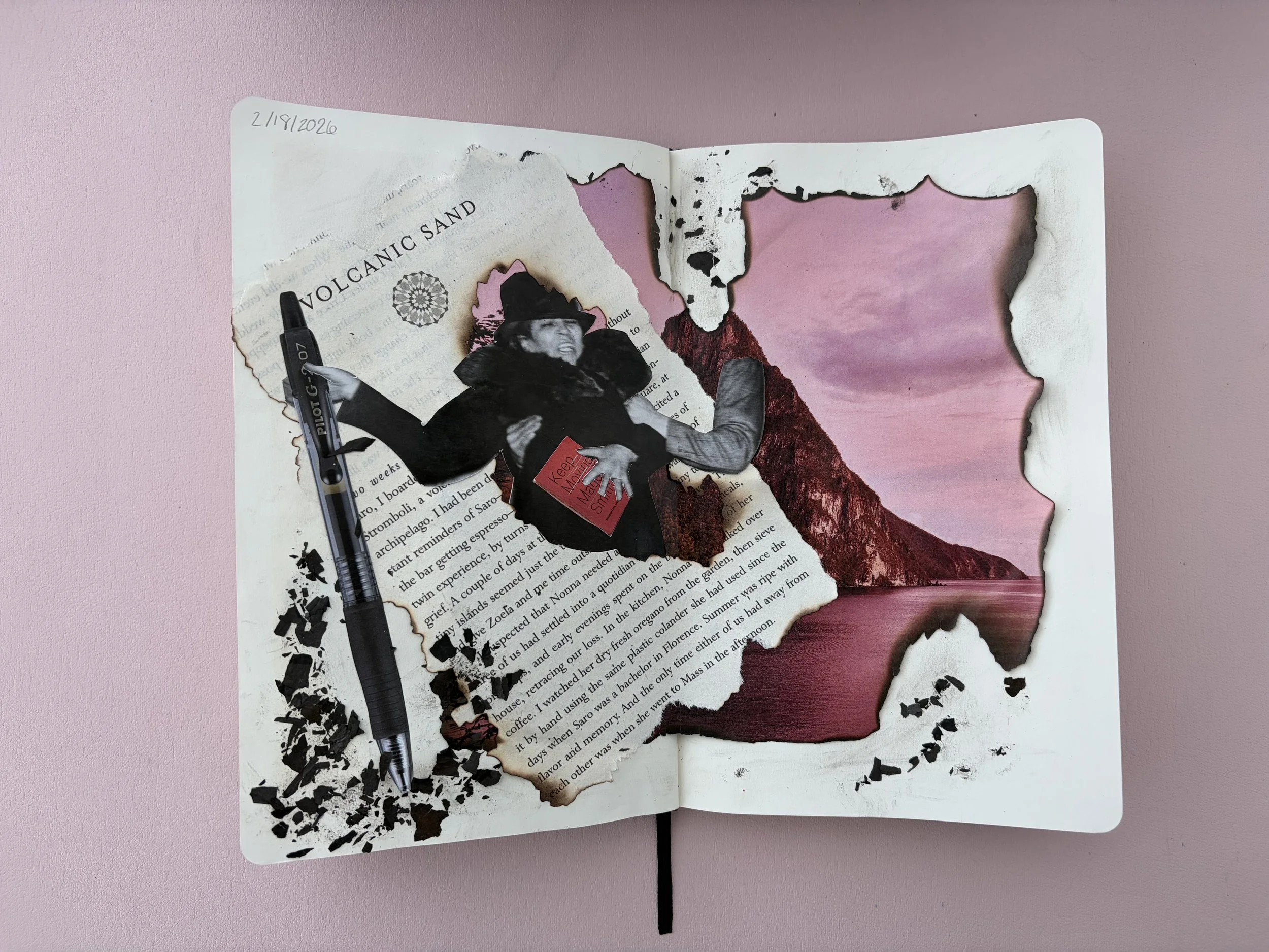 a mixed media collage in a sketchbook with a pink background. Collage includes torn paper with text, a black and white cutout of a woman holding a red book, a black pen, and a cutout of a landscape with a pink and purple sky and mountain and water sc