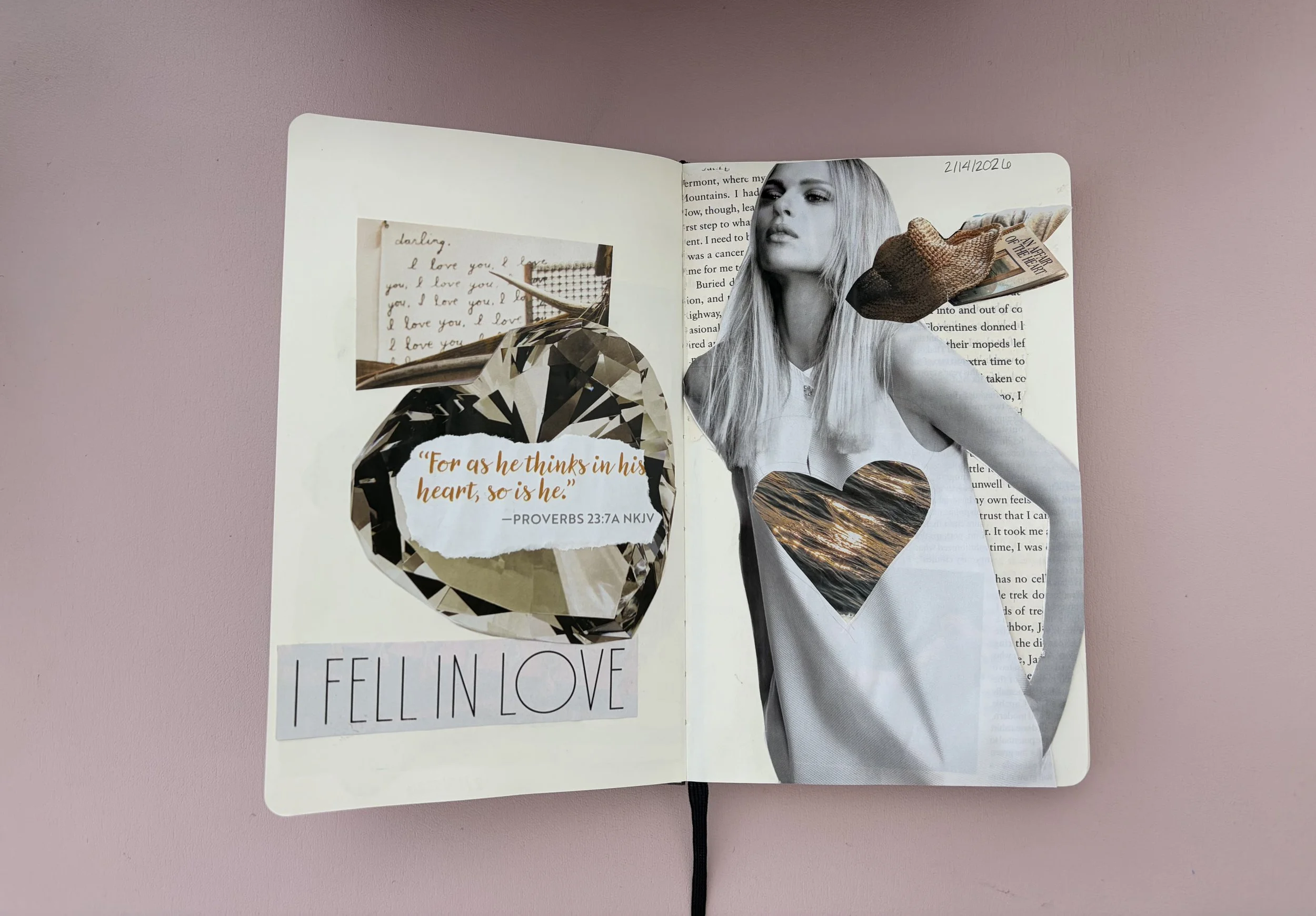 A decorated journal with black-and-white photos, a Bible verse quote, and cut-out imagery of a woman with a heart shape on her dress, set against a pink background.