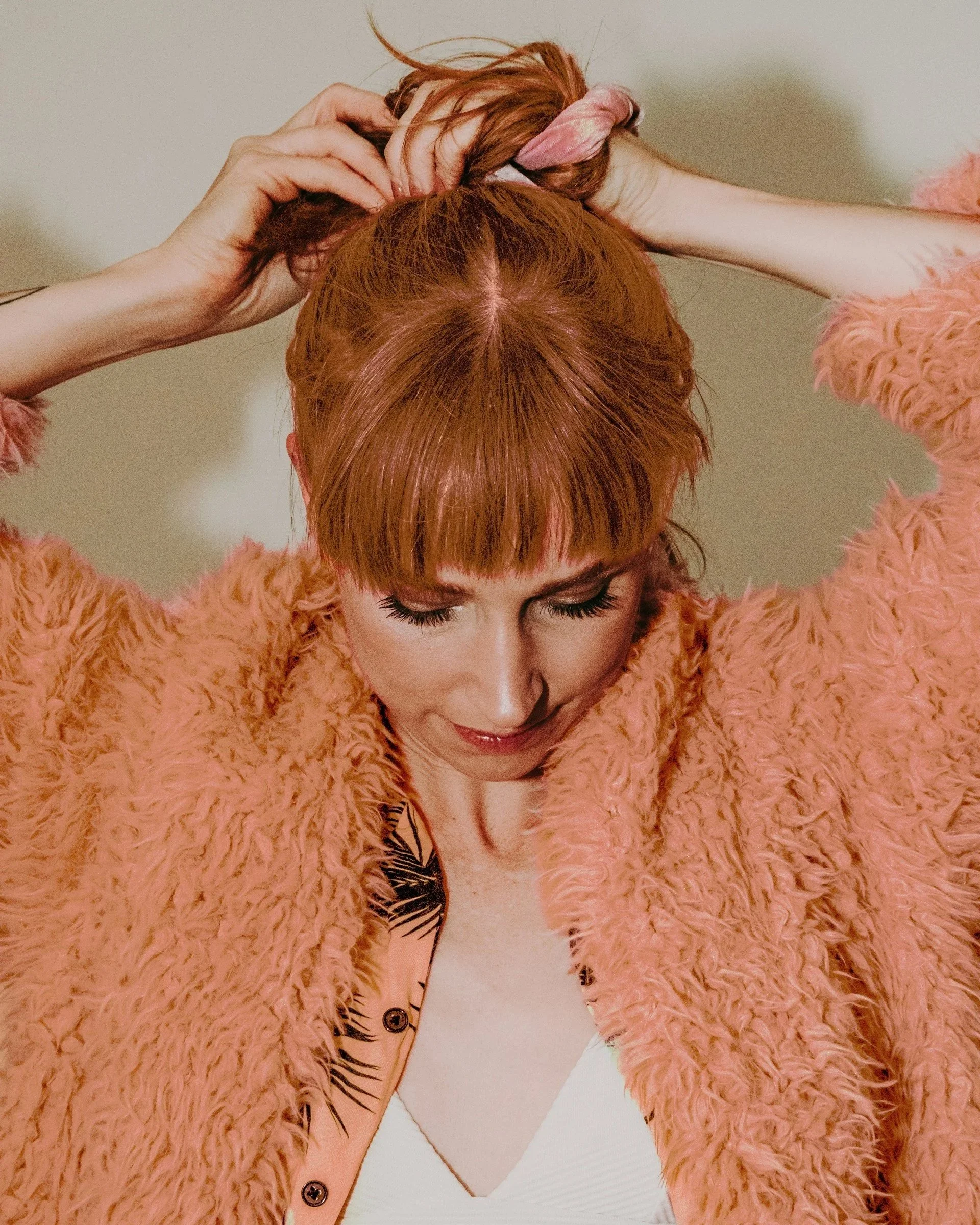 Woman in peach looking down