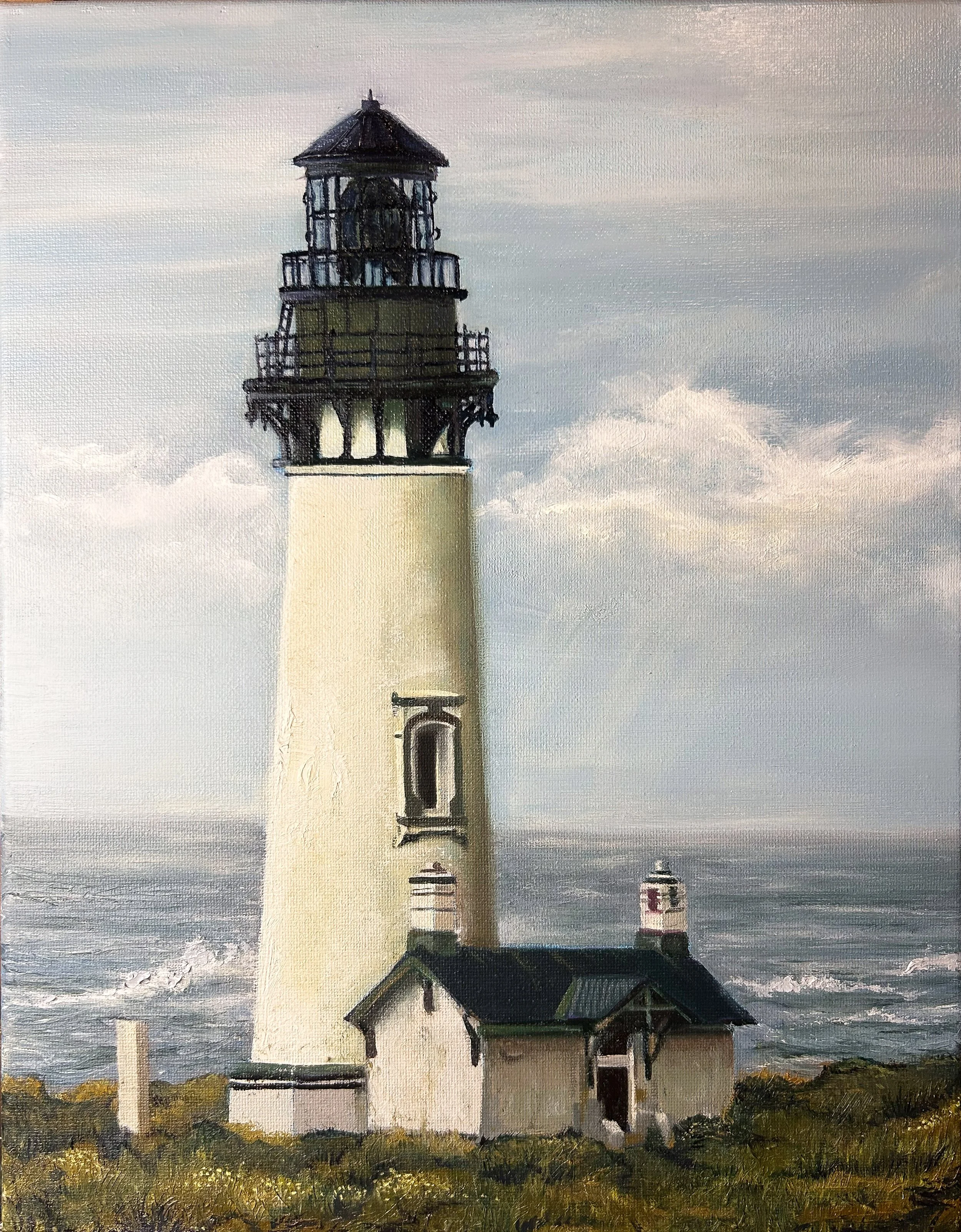 A lighthouse situated on a grassy coast with an ocean in the background, under a cloudy sky.