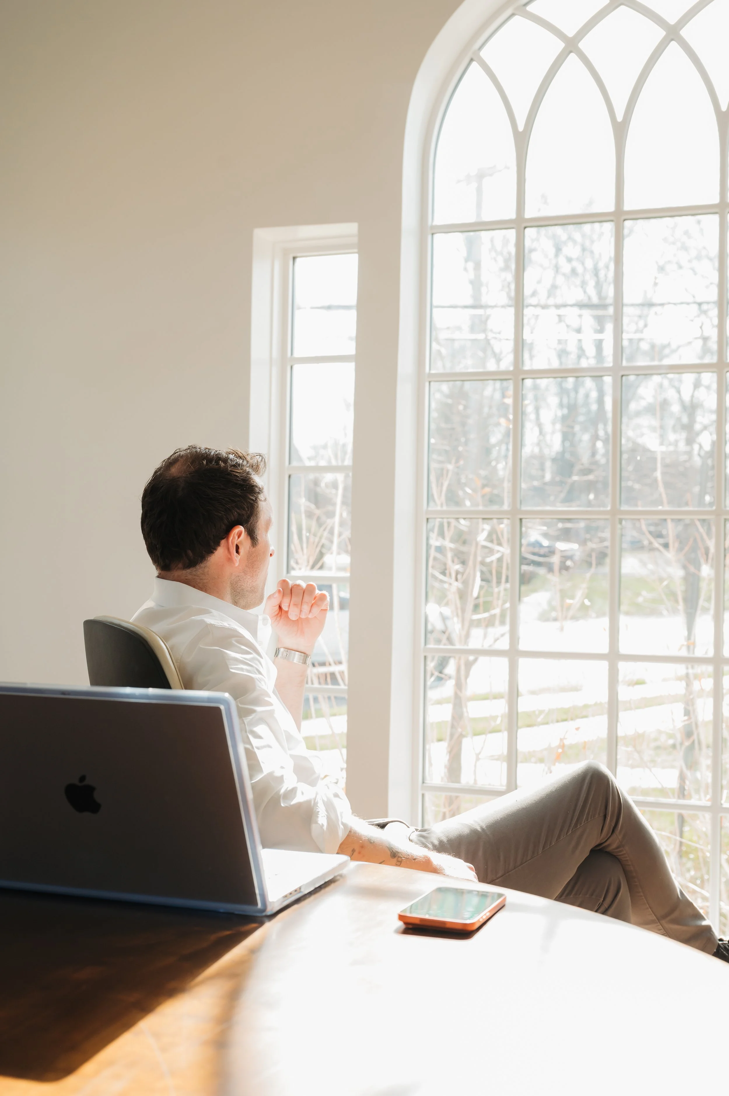 A branding portrait of a professional working with his laptop and phone 