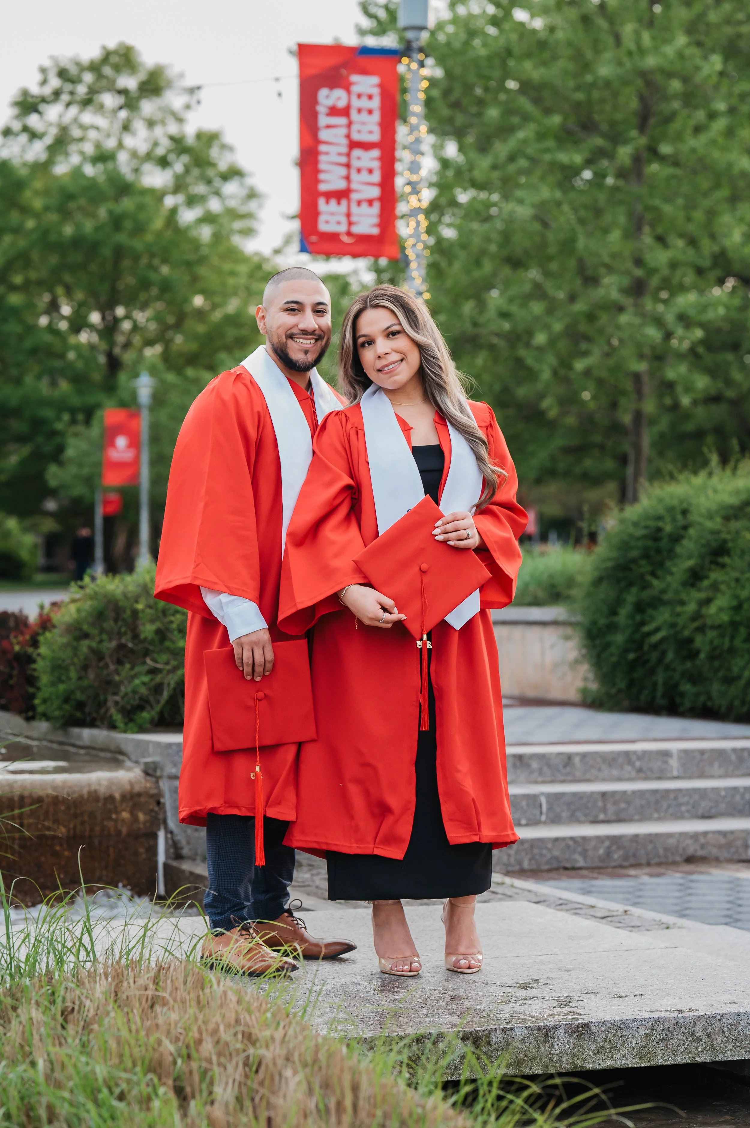 college-grad-couple-posing-campus-session.jpg