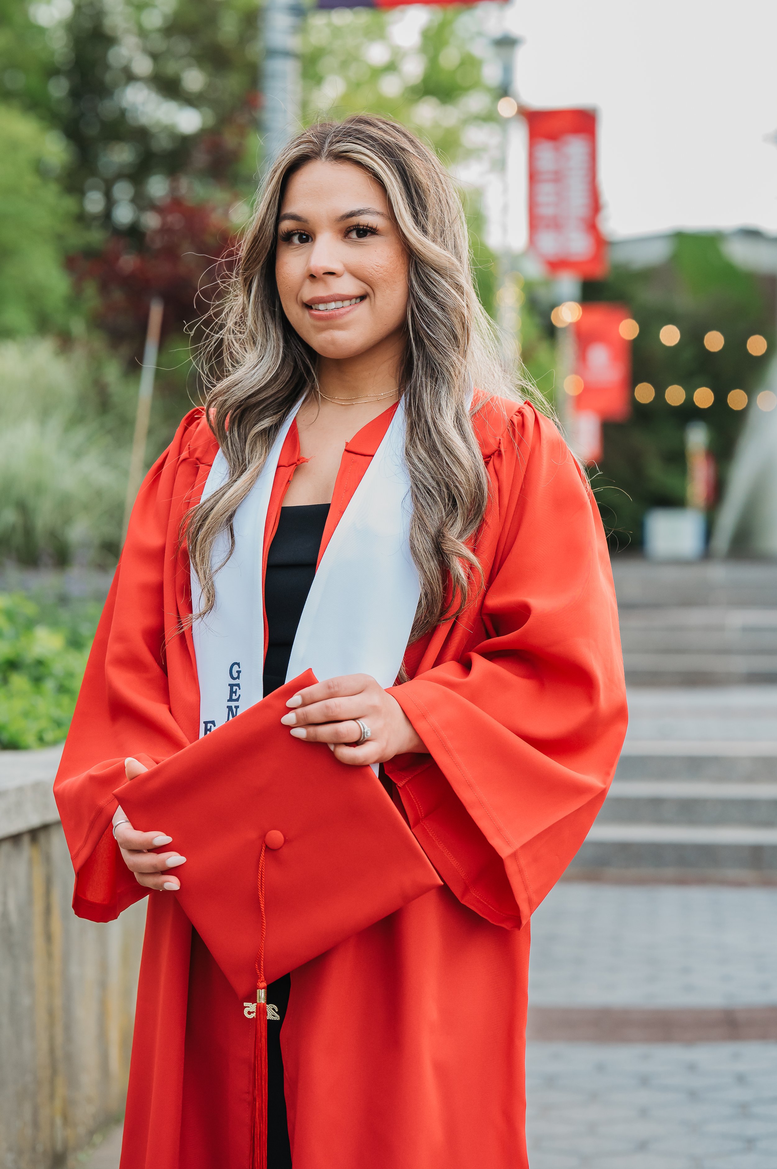 stony-brook-university-grad-photo-holding-cap.jpg